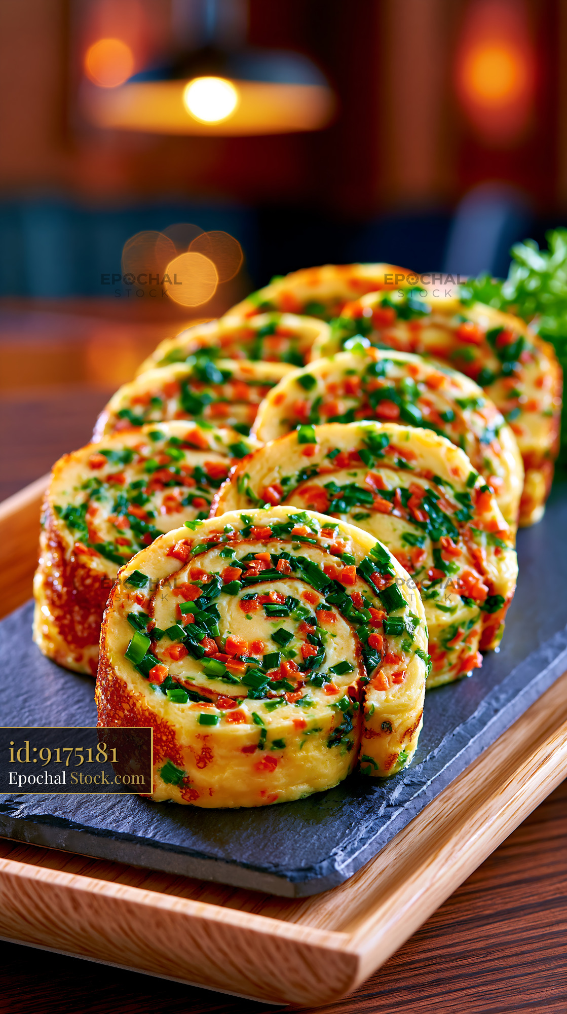Korean rolled omelet gyeran mari with scallions and carrots on slate - stock photo