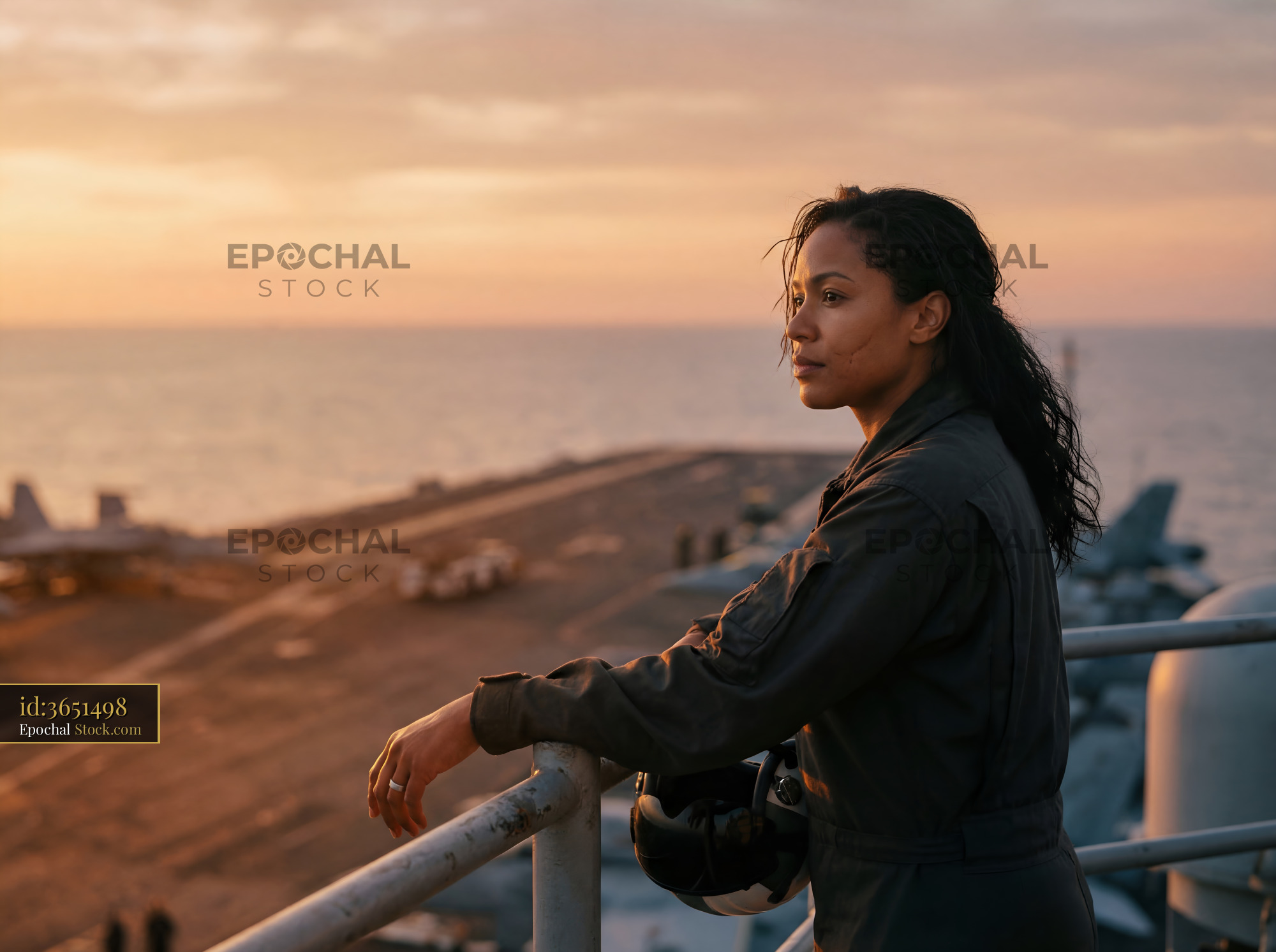 Woman gazes at the sea from a ship at sunset Premium Stock Image - stock photo