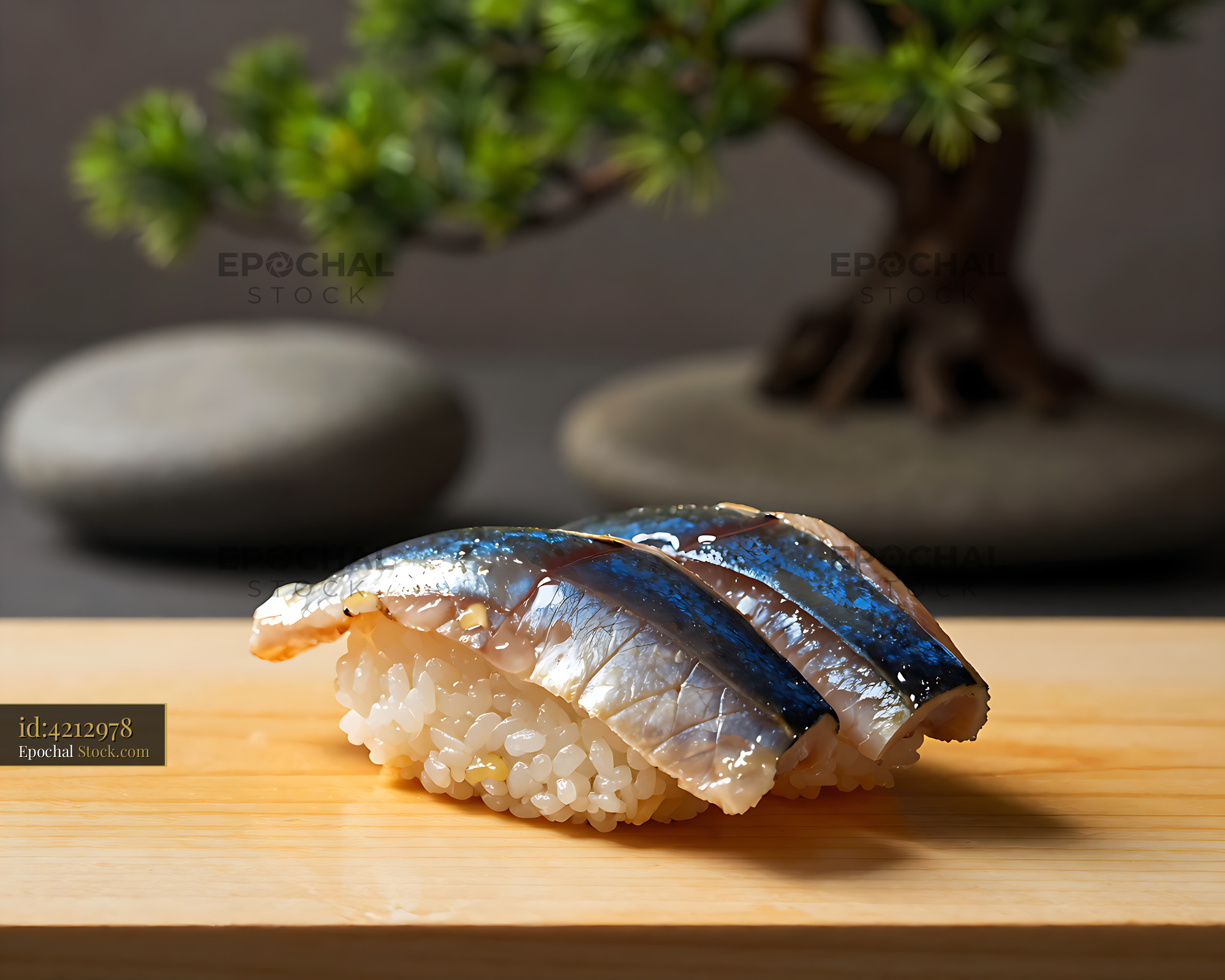 Traditional Sanma no Oshizushi served on a wooden board with bonsai - stock photo