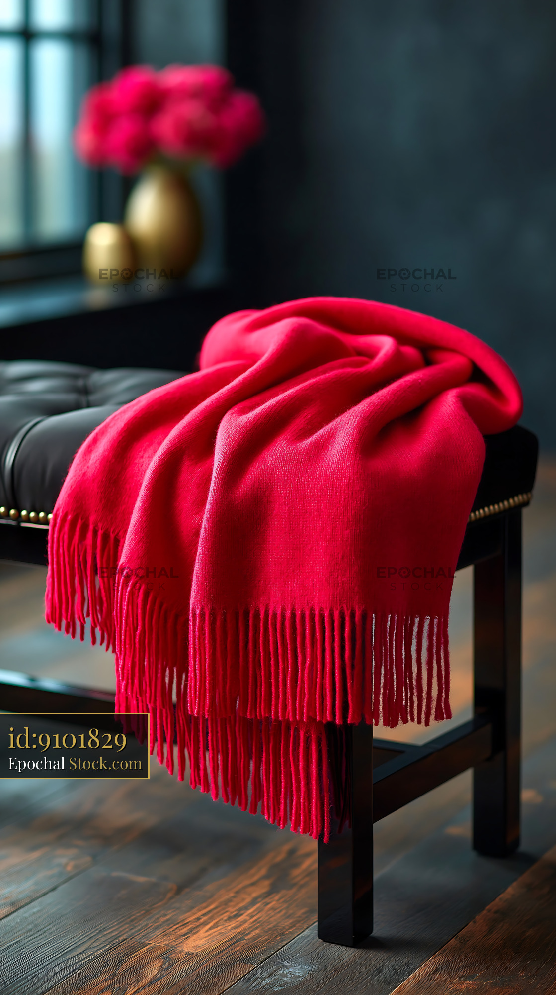 Red cottage garden bench blanket draped on a black leather ottoman