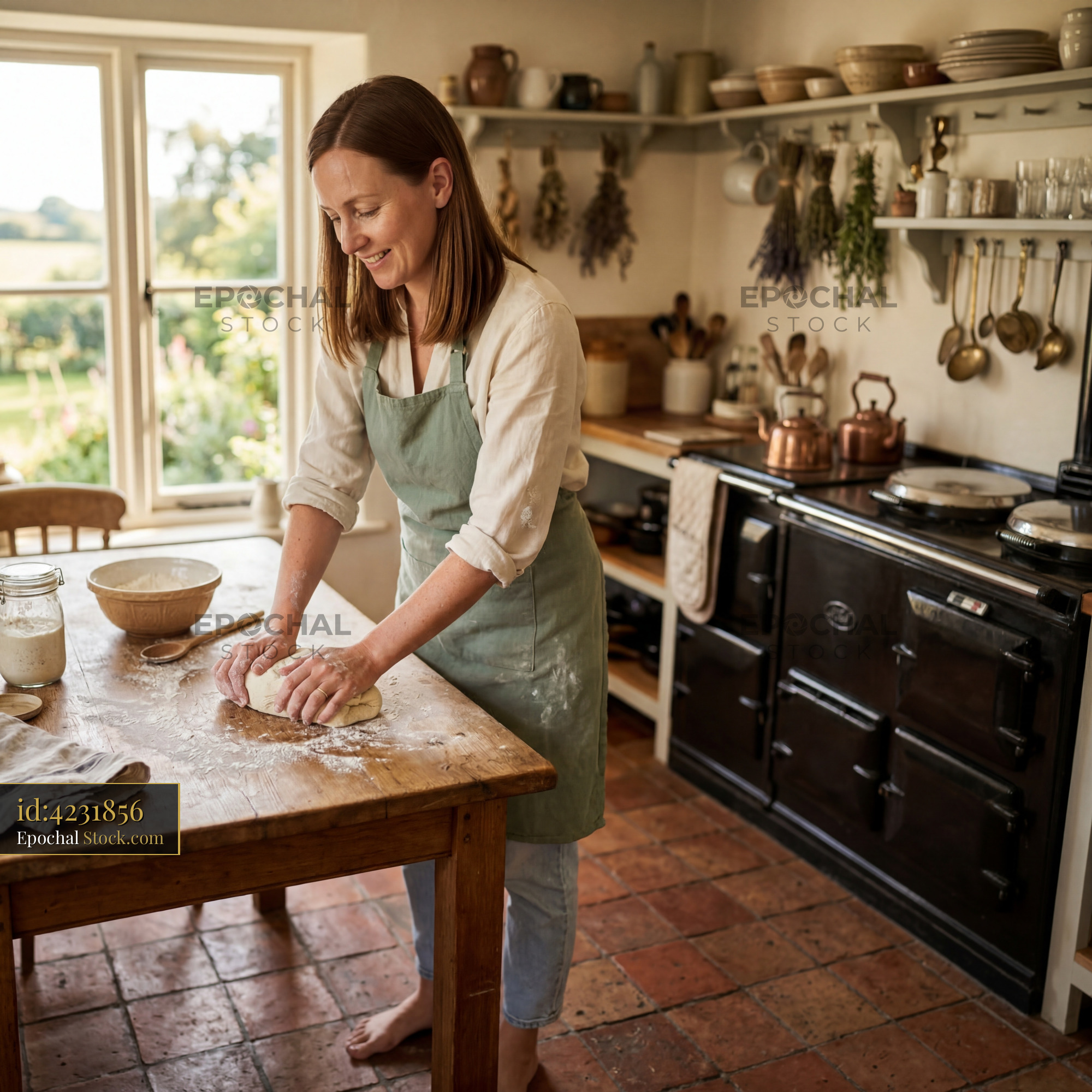 Woman kneads dough in home kitchen in the countryside Premium Stock Image - stock photo