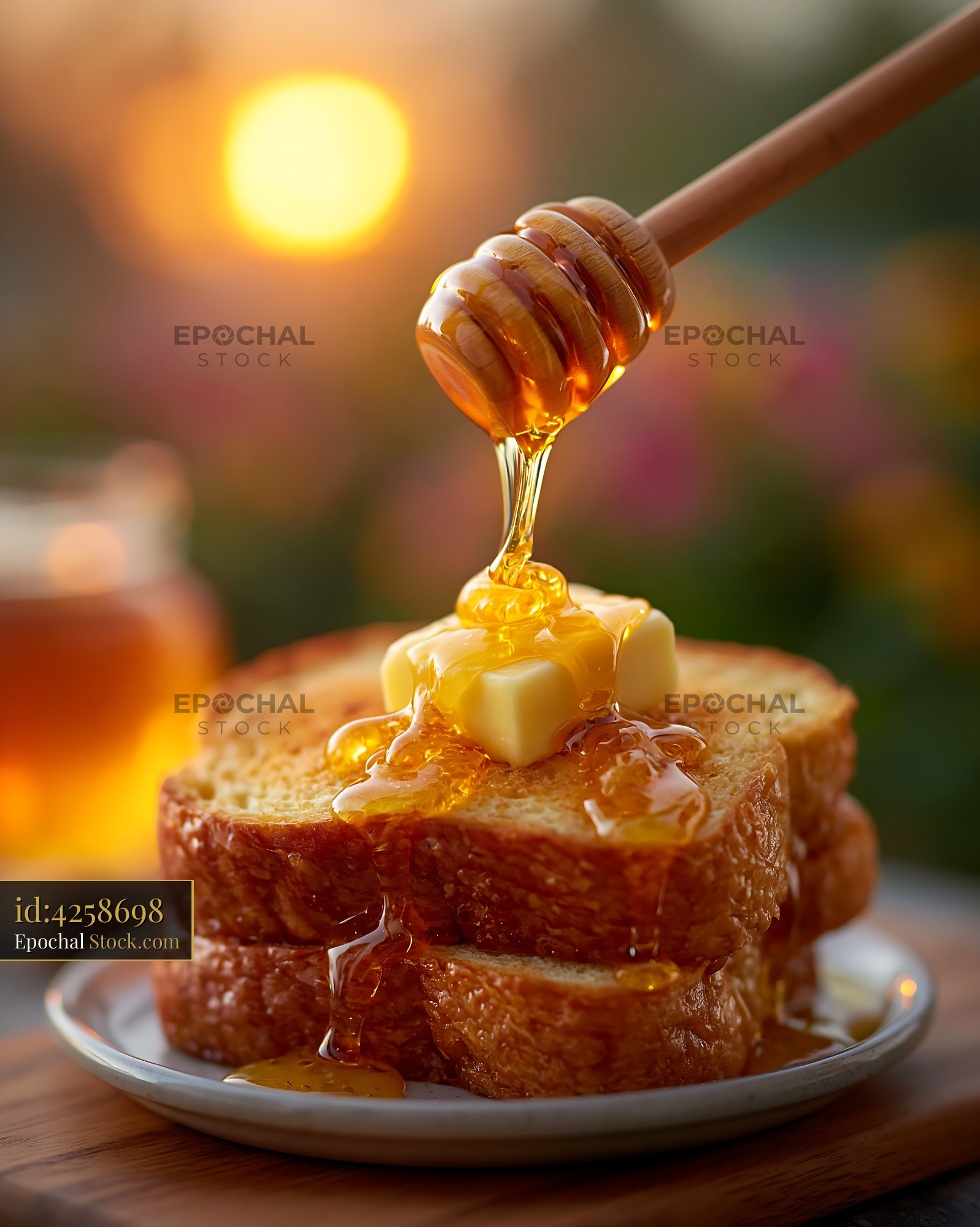 Honey drizzling on toasted amish friendship german bread at sunset - stock photo