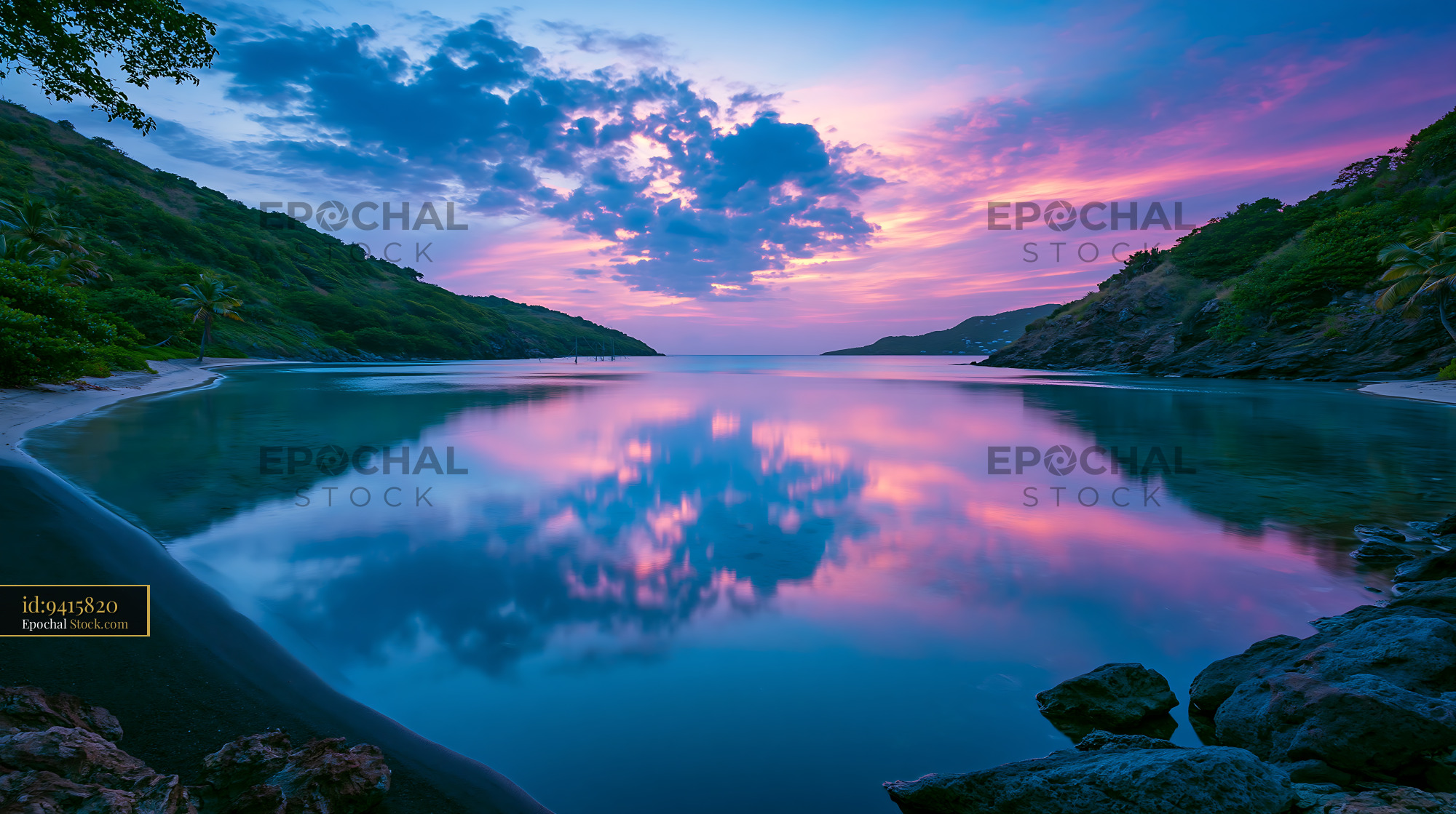 Tropical bay with pink sunset reflecting on calm water at dusk - stock photo