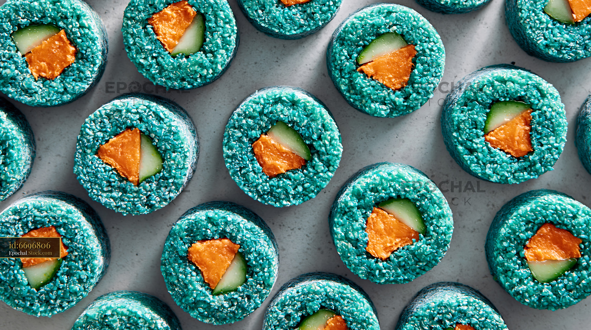 Maki sushi rolls with blue spirulina rice sweet potato and cucumber - stock photo