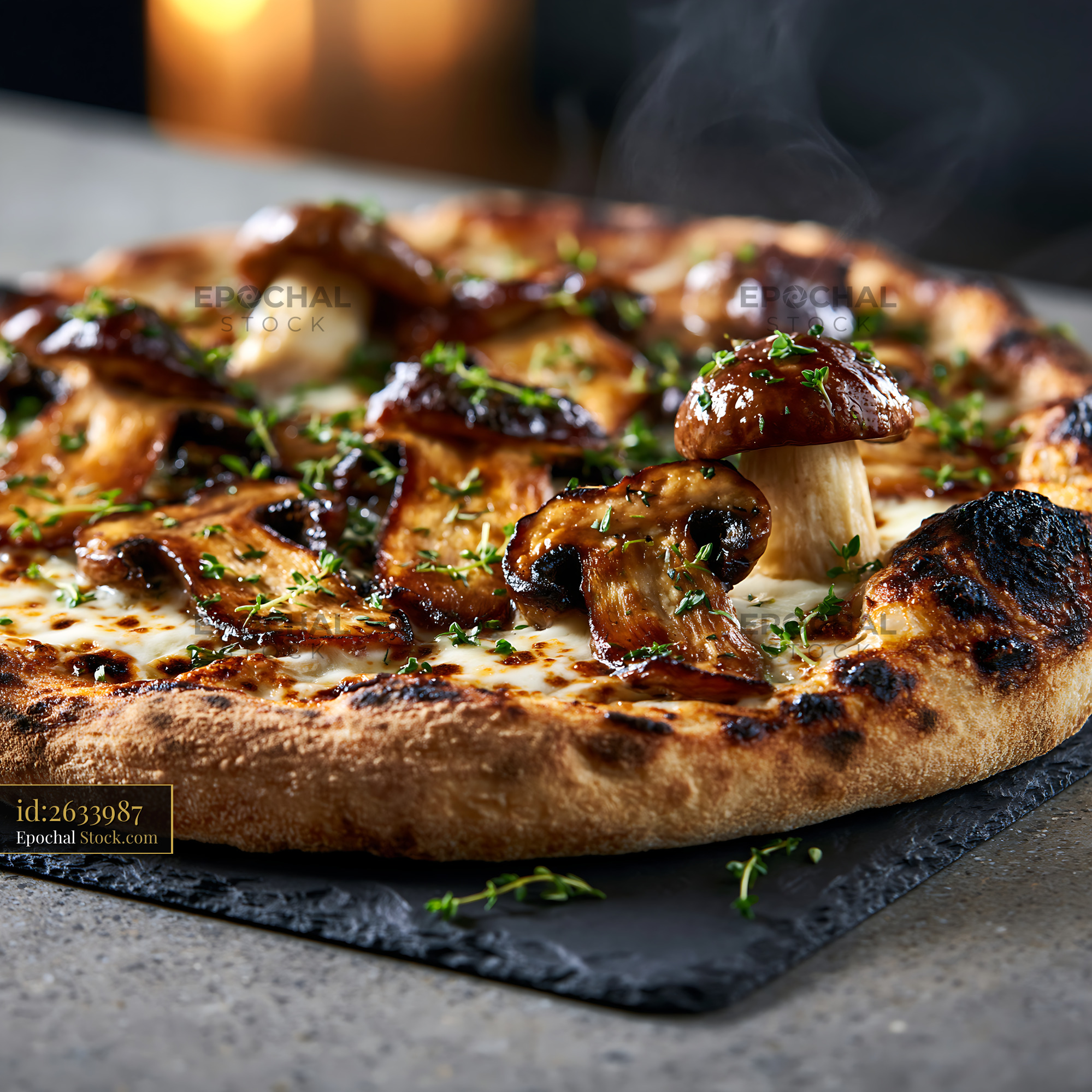 Gourmet porcini mushroom pizza with fresh thyme and rising steam - stock photo