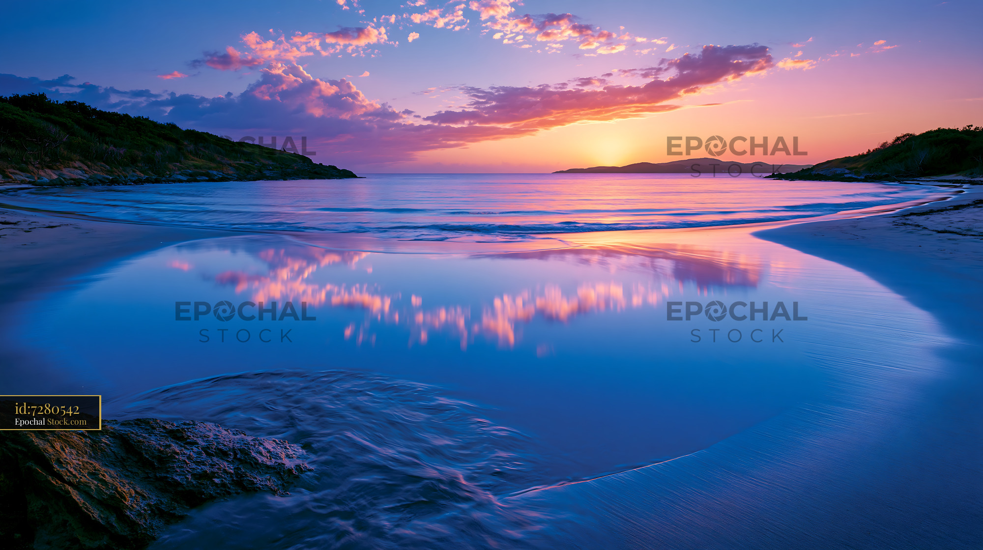 Vibrant sunset over a calm tropical bay with cloud reflections - stock photo