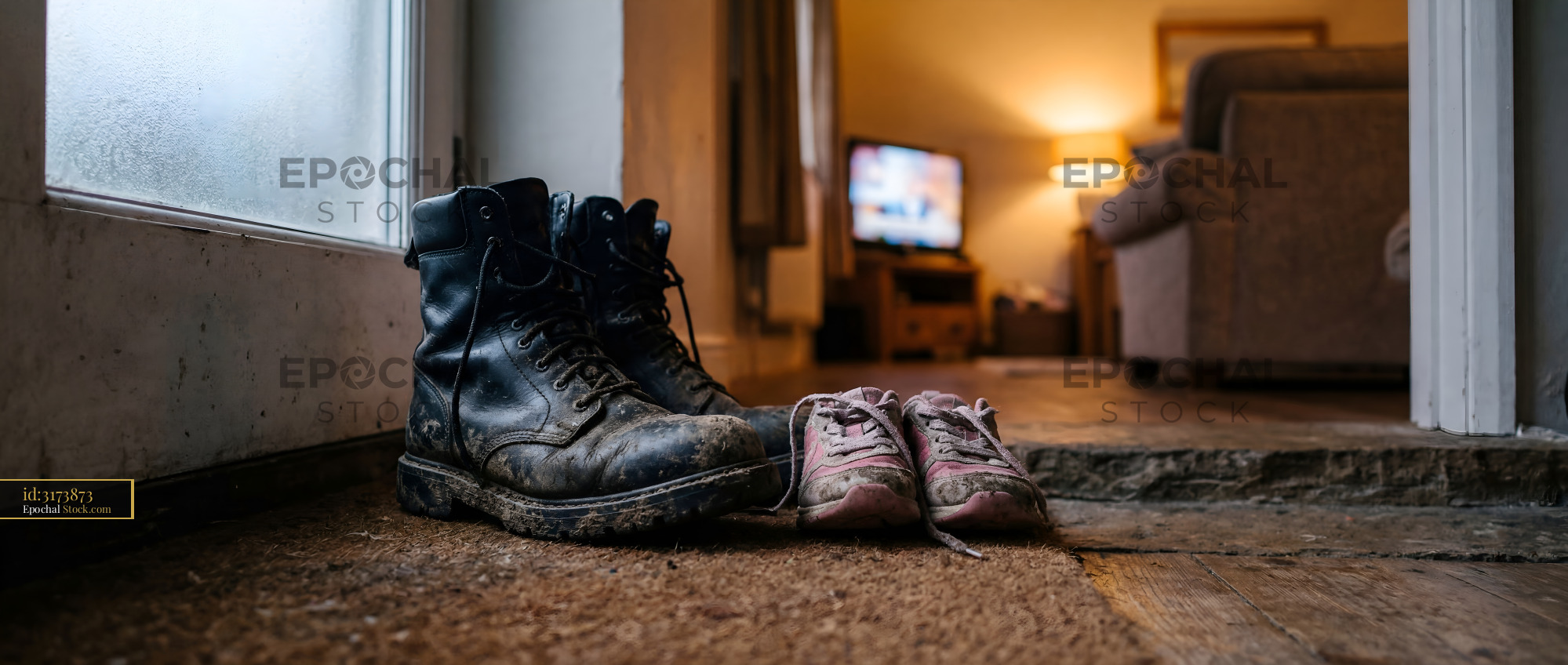 Boots and shoes placed by the door in a home setting Premium Stock Photo - stock photo