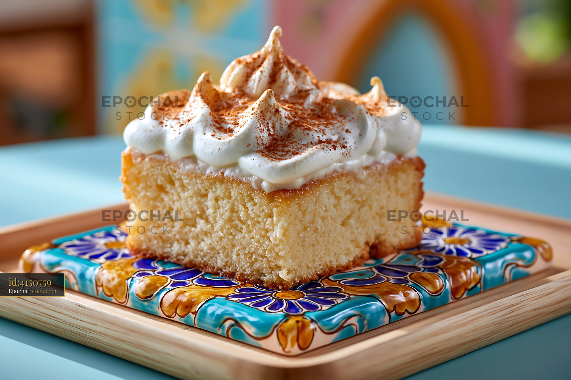 Tres leches cake with whipped cream and cinnamon on a mexican tile - stock photo