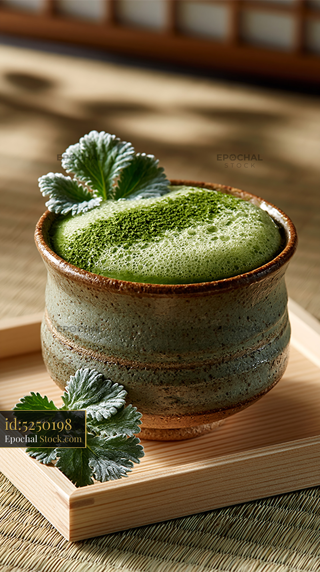 Mugwort herb smoothie with green foam in a rustic ceramic cup - stock photo