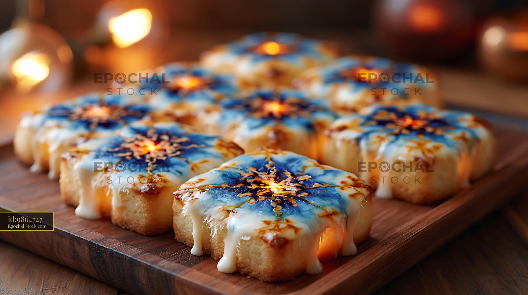 Festive snowflake pastries with blue icing on a wooden tray - stock photo