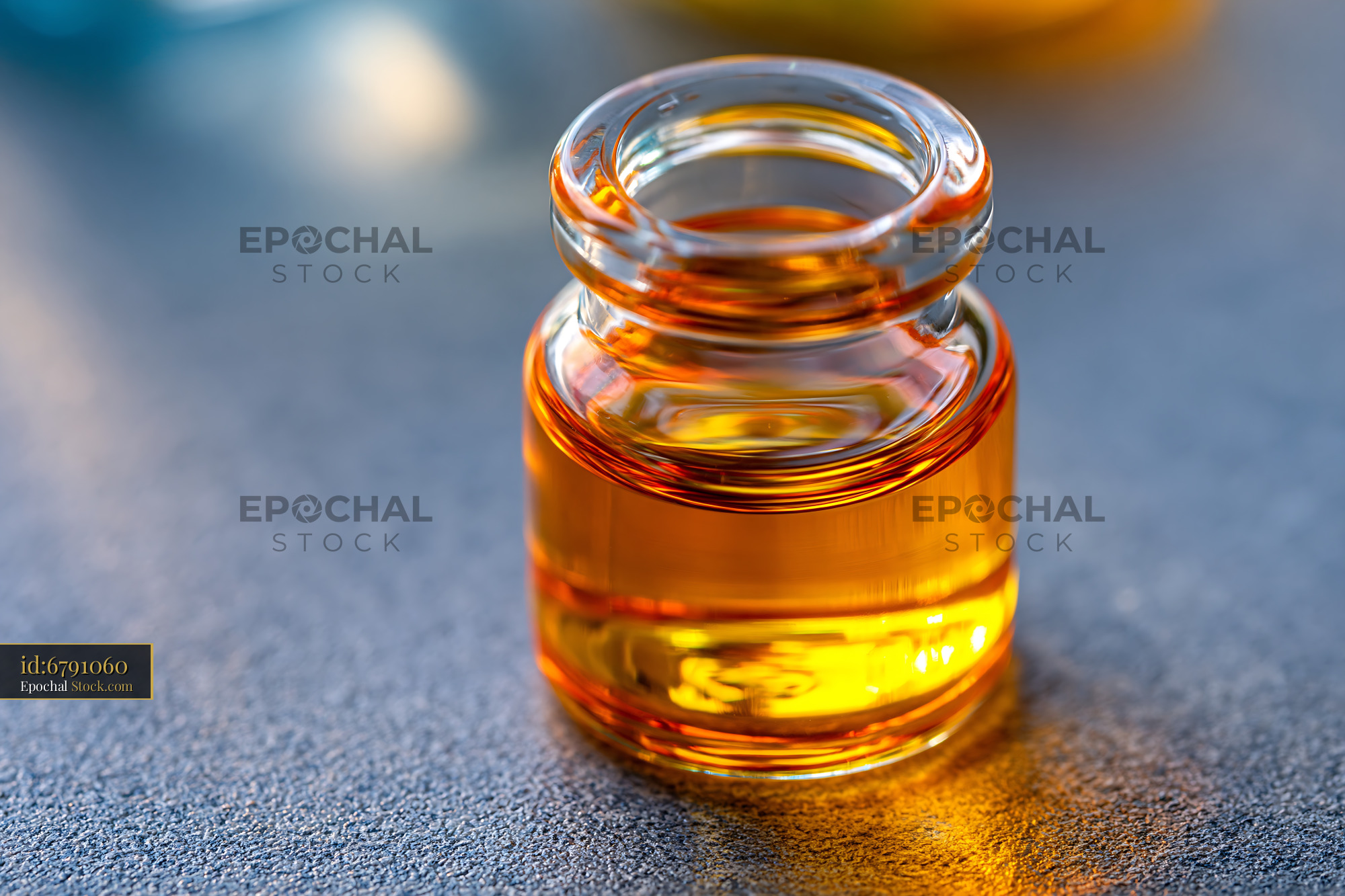 Small glass vial with amber liquid for lanthanide metal isotope antibo - stock photo