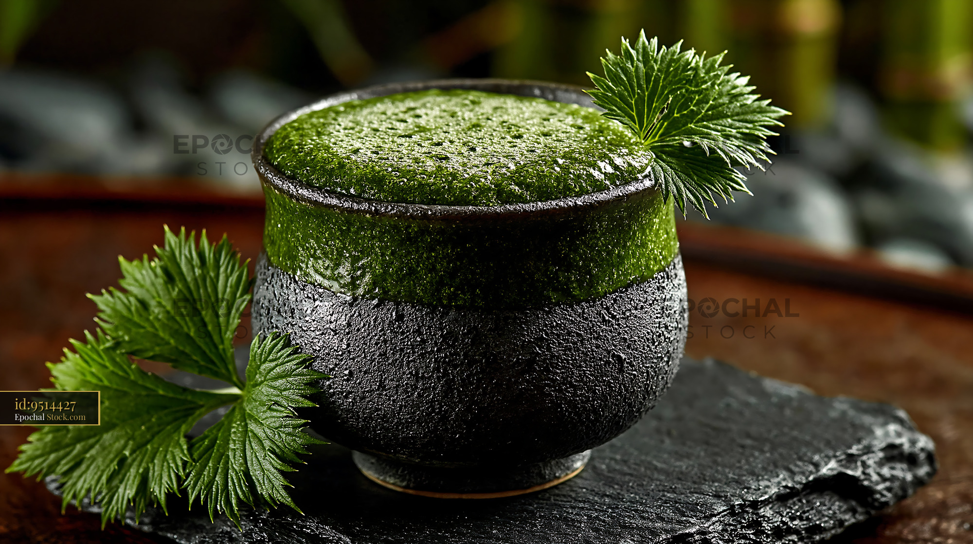 Healthy mugwort herb smoothie in a rustic ceramic cup on stone - stock photo