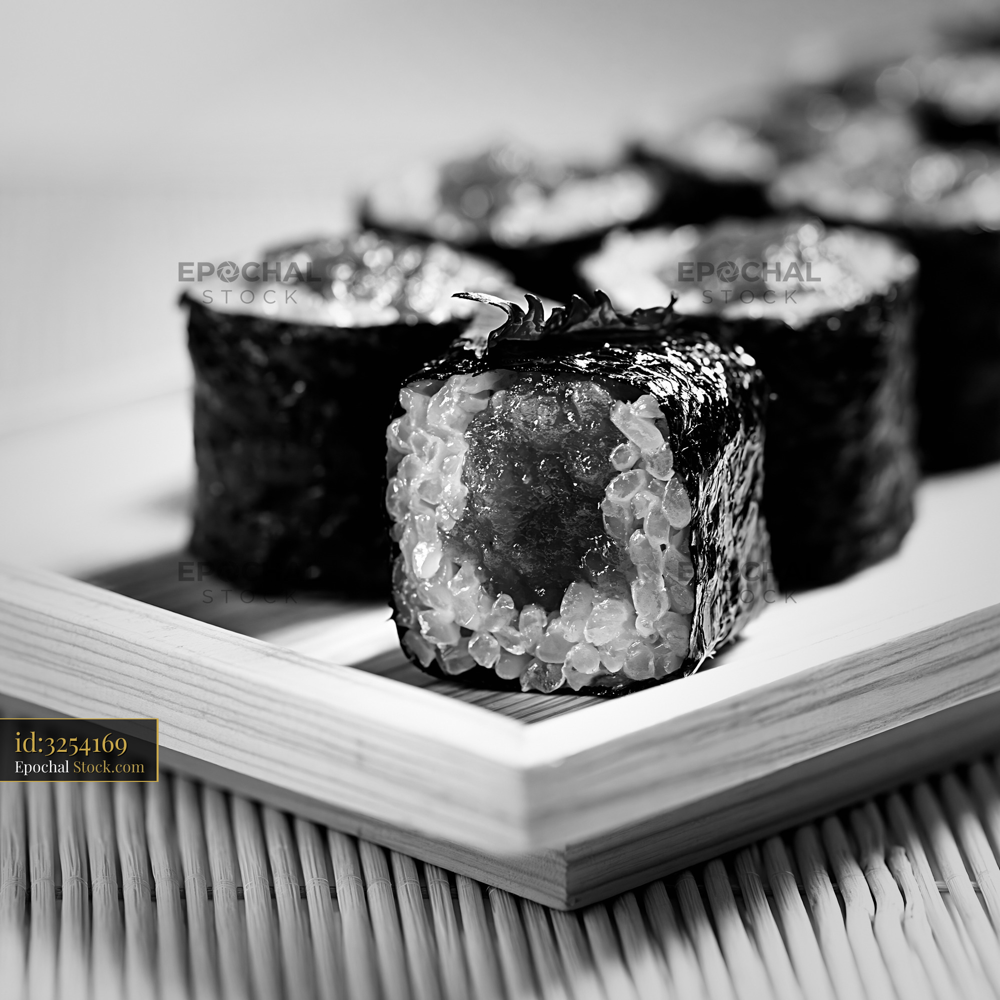 Salted plum umeboshi sushi rolls on a wooden tray in monochrome - stock photo