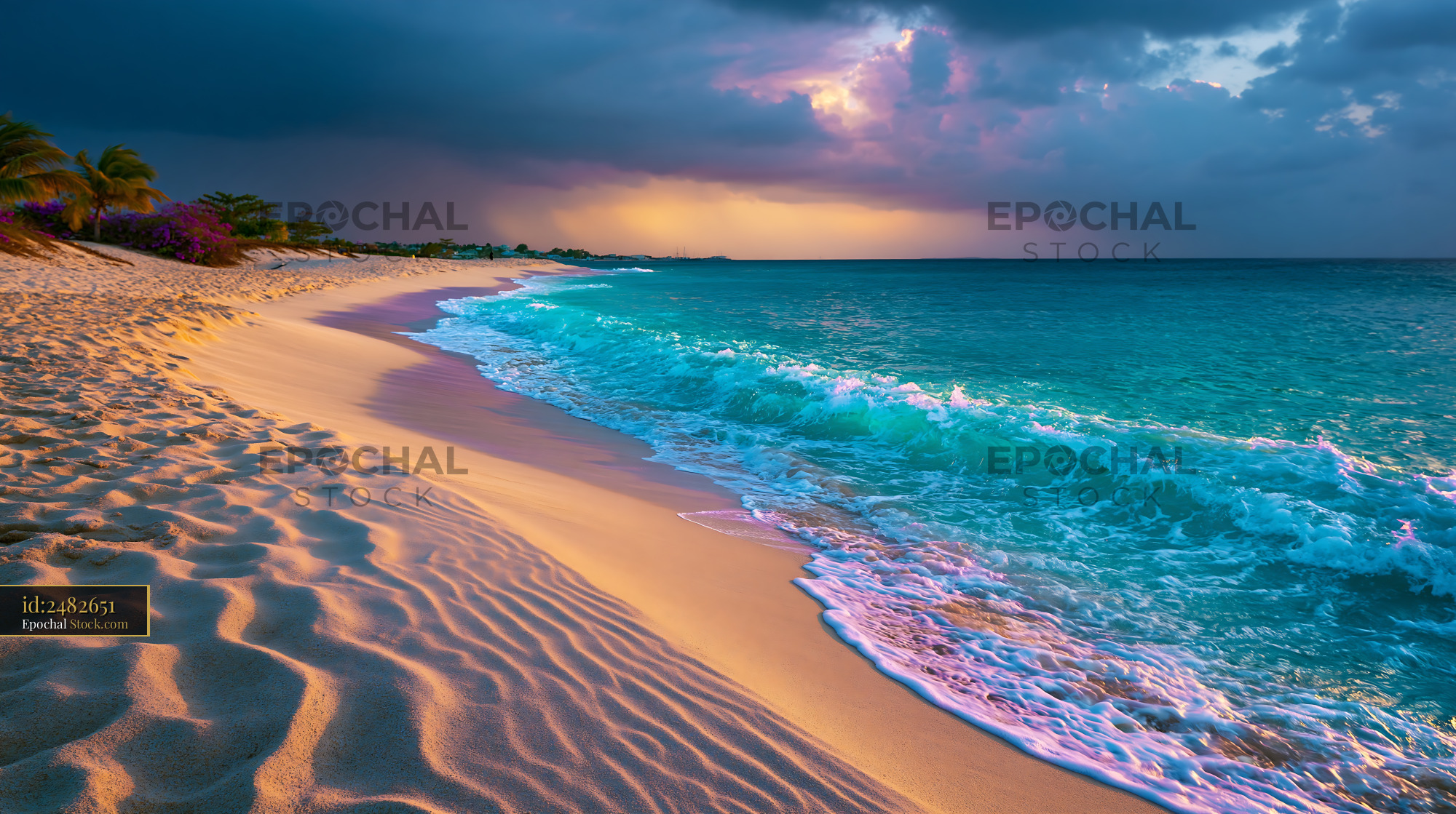 Turquoise waves washing onto sandy beach under dramatic sunset sky - stock photo