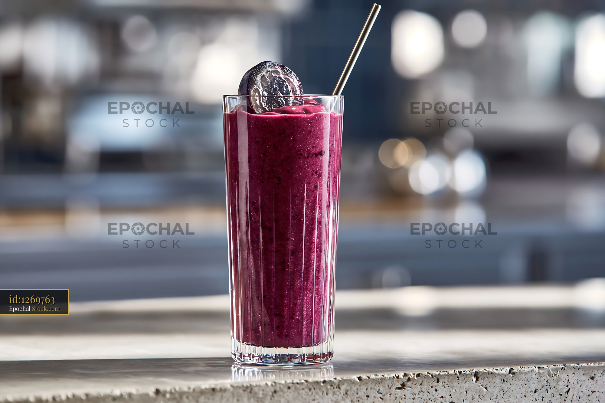 Fresh kyoho grape smoothie in a tall glass with a metal straw - stock photo