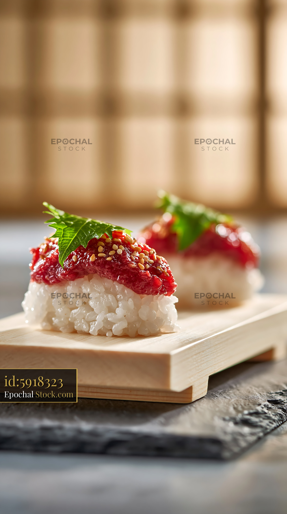 Traditional salted plum umeboshi sushi with shiso leaf on wooden board - stock photo