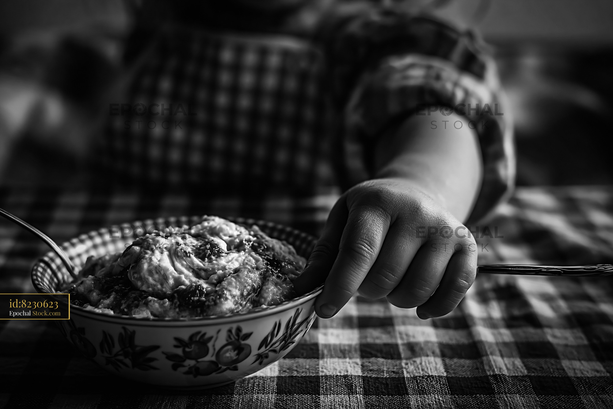 Child reaching for a bowl of almond paste ice cream with jam
