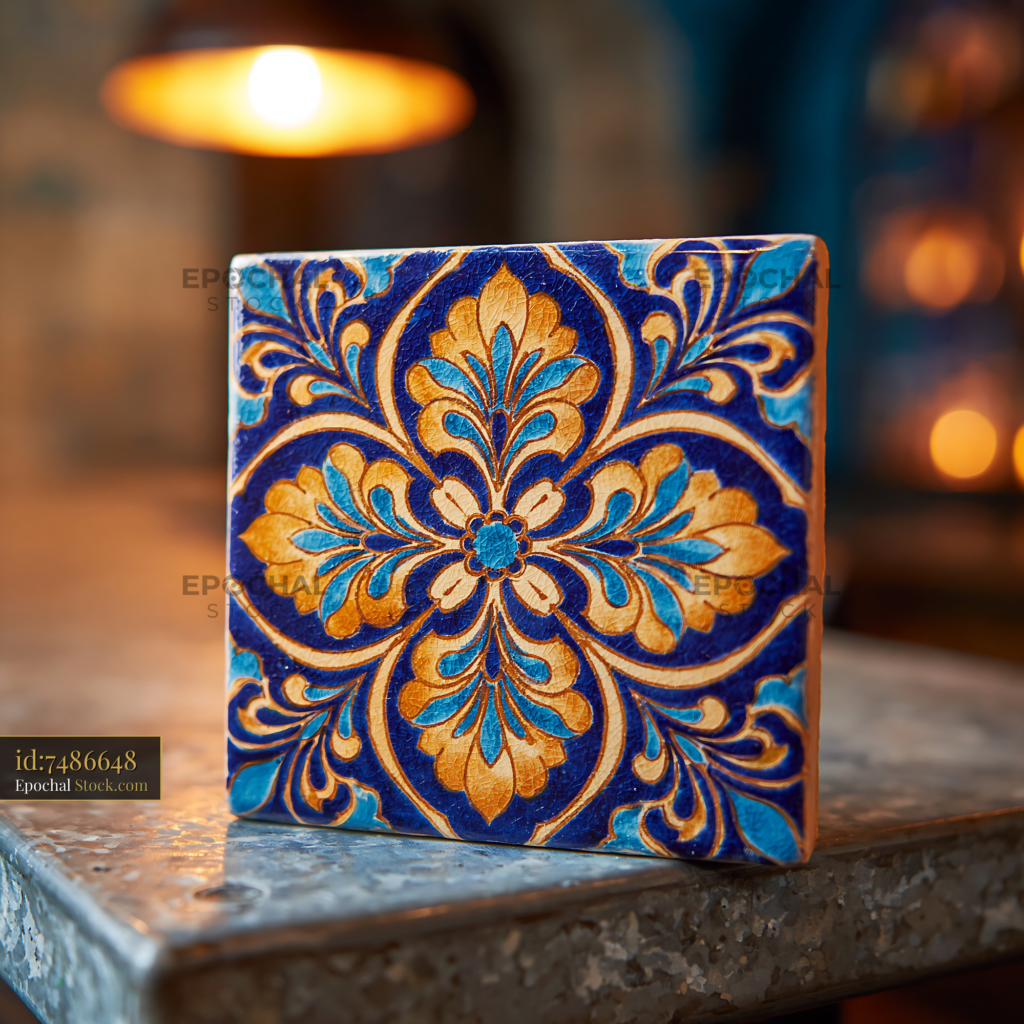 Traditional handcrafted ceramic tile with blue and gold floral pattern - stock photo