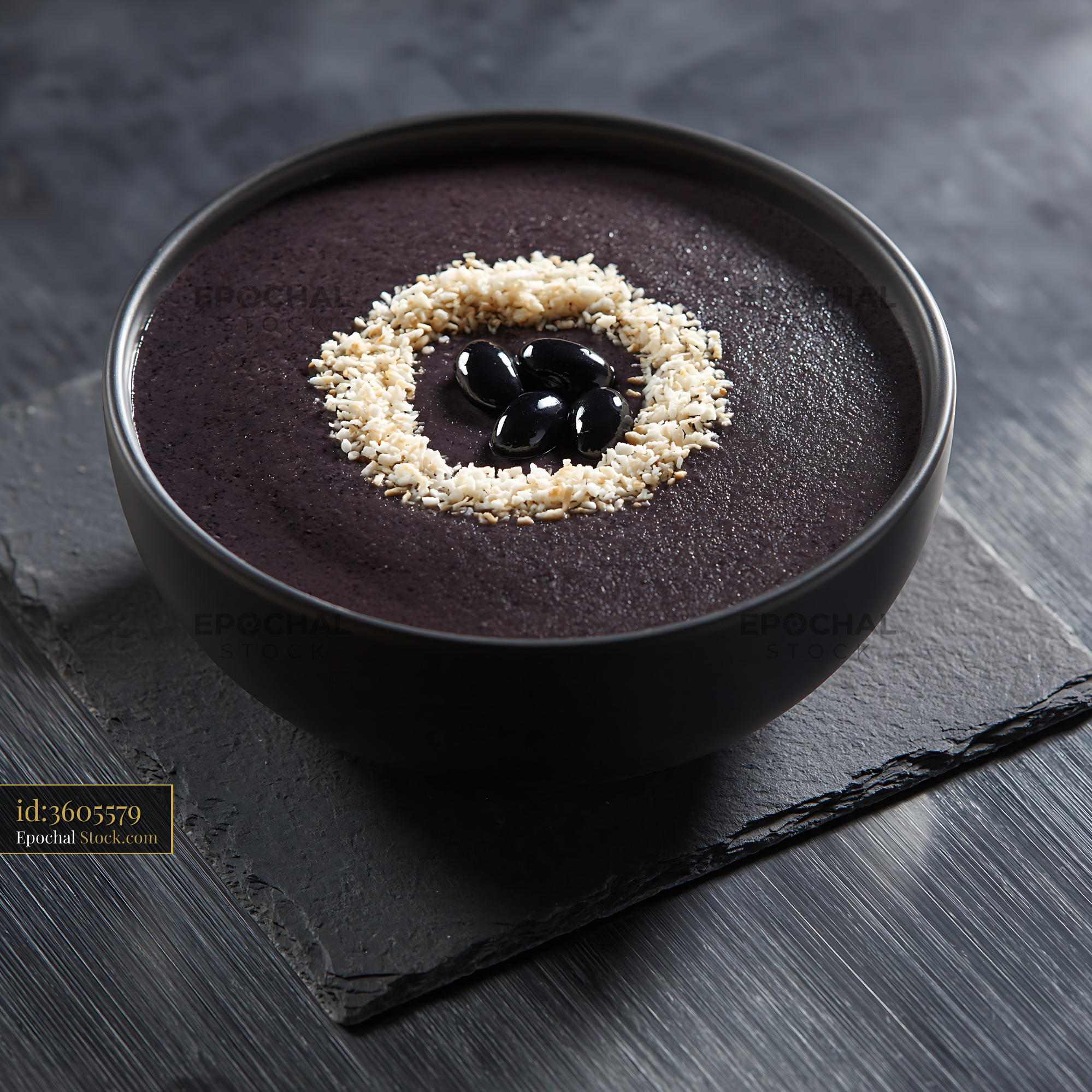 Healthy black bean smoothie bowl topped with seeds and whole beans - stock photo