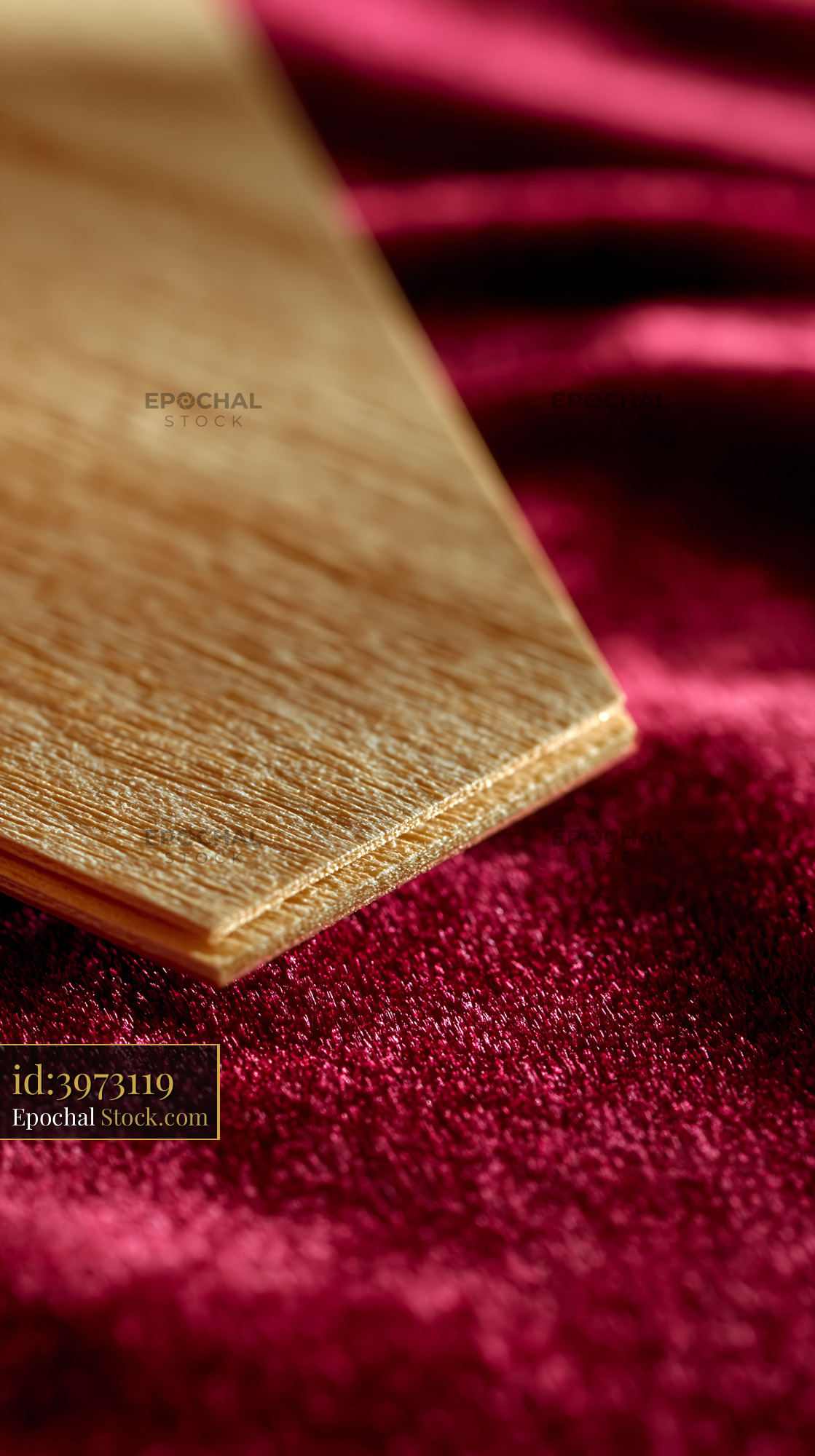 Elegant wooden invitation card on red velvet for luxury events - stock photo