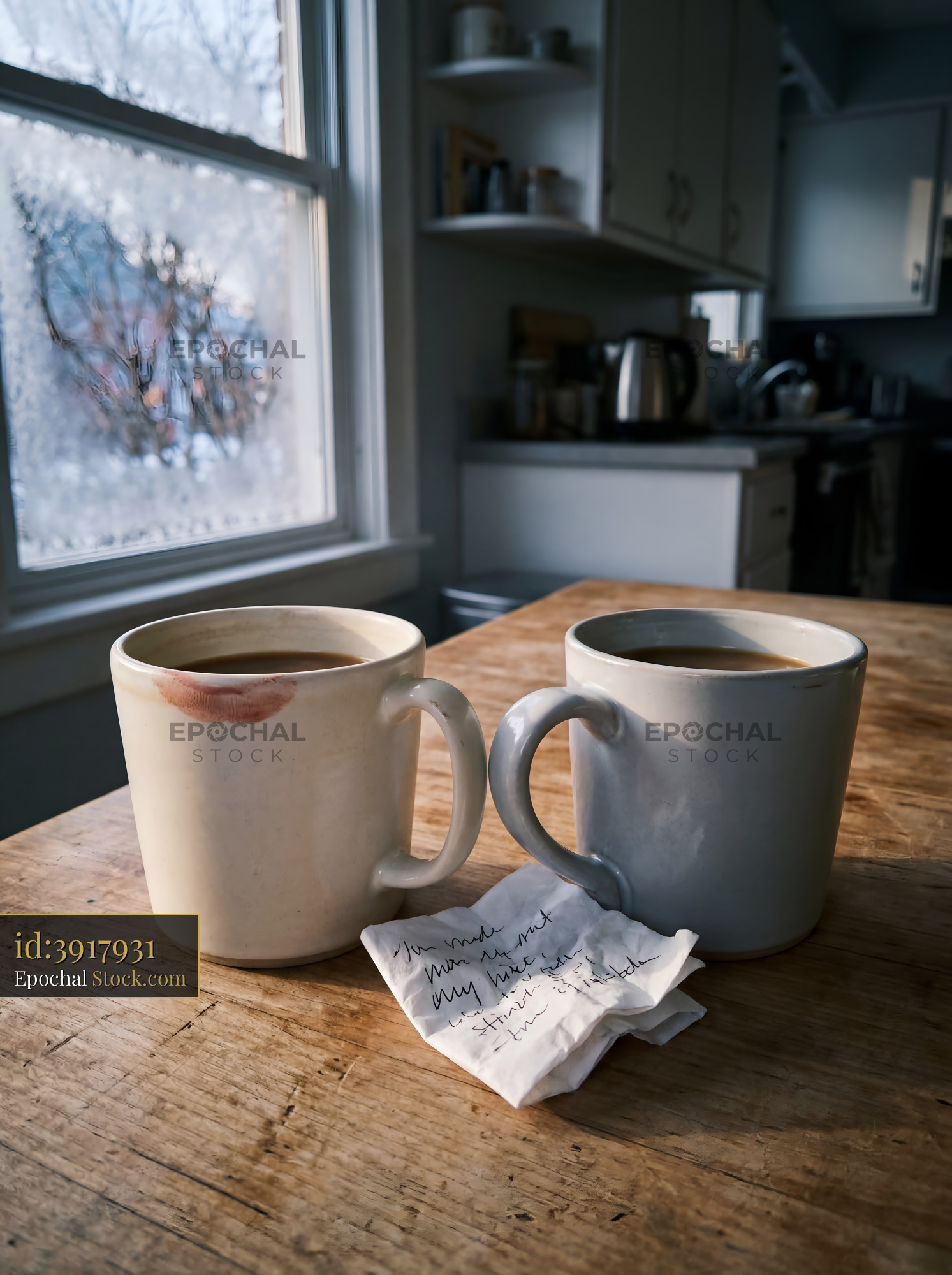 Two mugs sit on a table with a note beside them Premium Stock Photo - stock photo