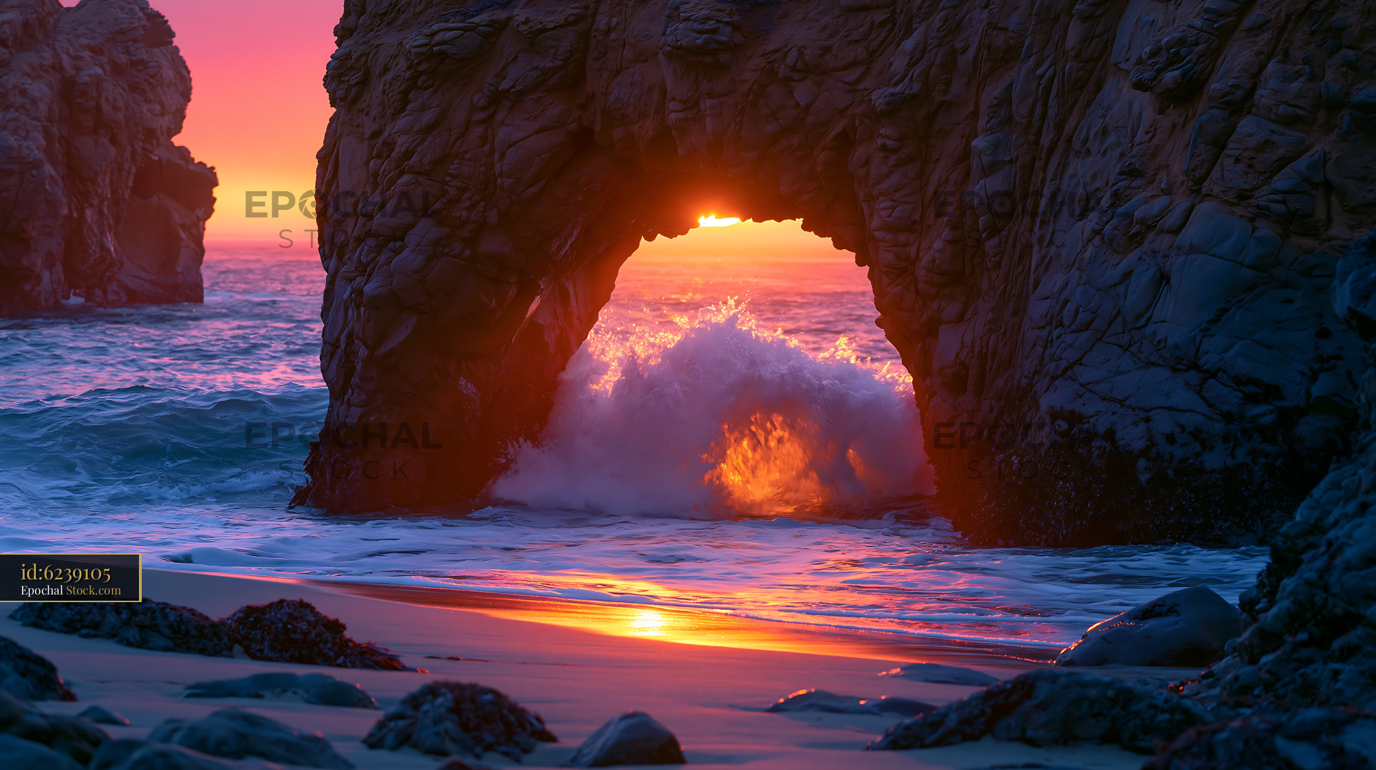 Sunlight shining through Pfeiffer Beach sea arch with crashing wave - stock photo