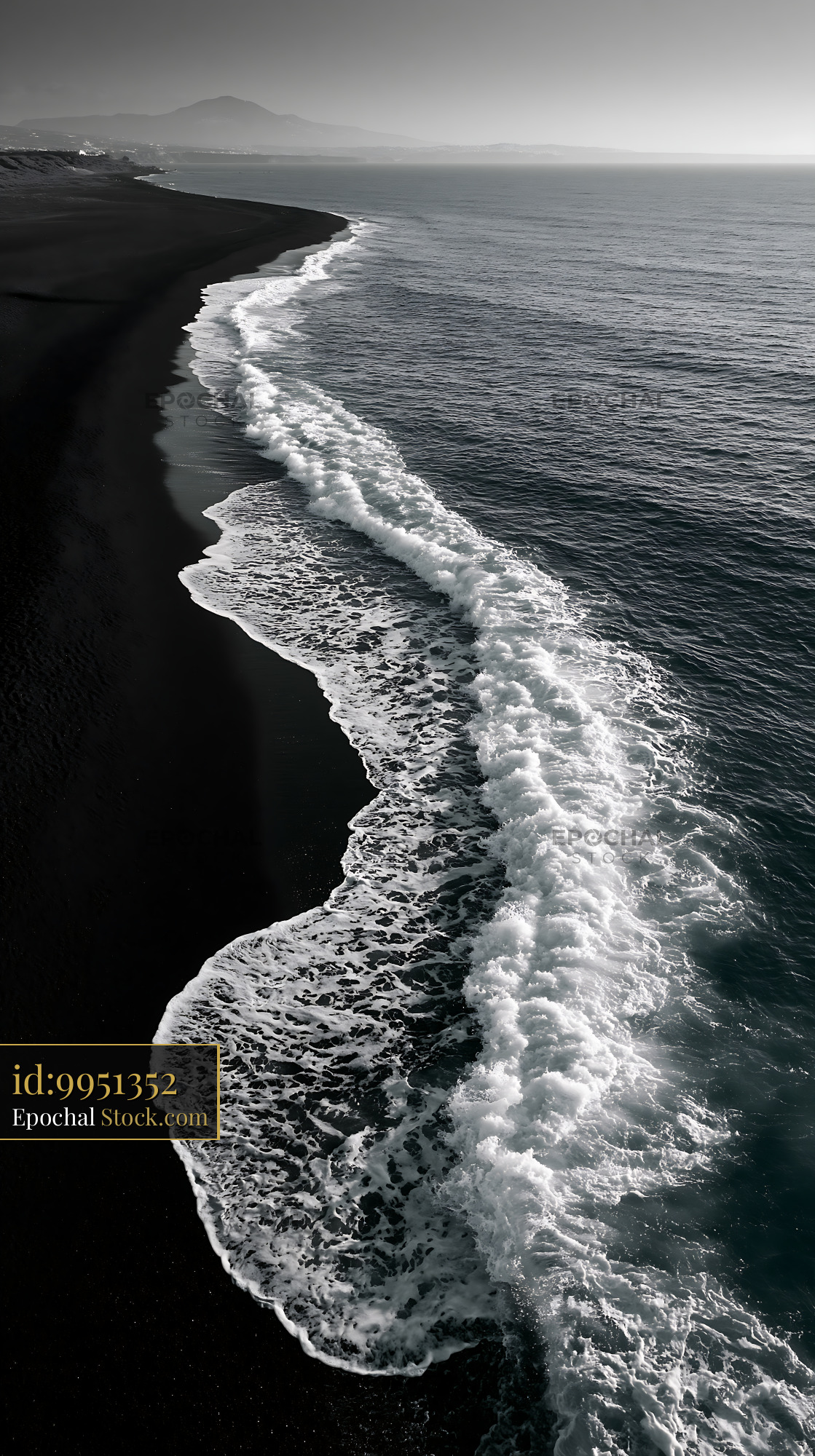 Dramatic black and white aerial view of waves on a volcanic beach - stock photo