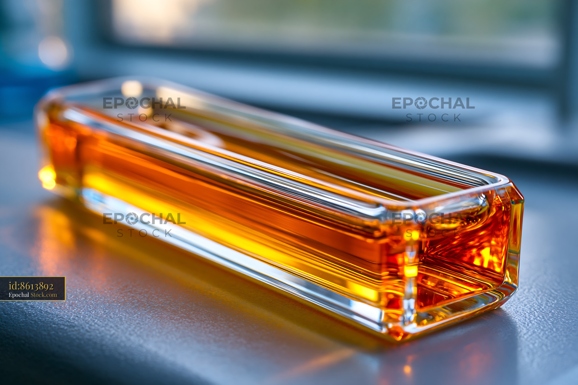 Glass cuvette with amber liquid for protein aggregation analysis - stock photo