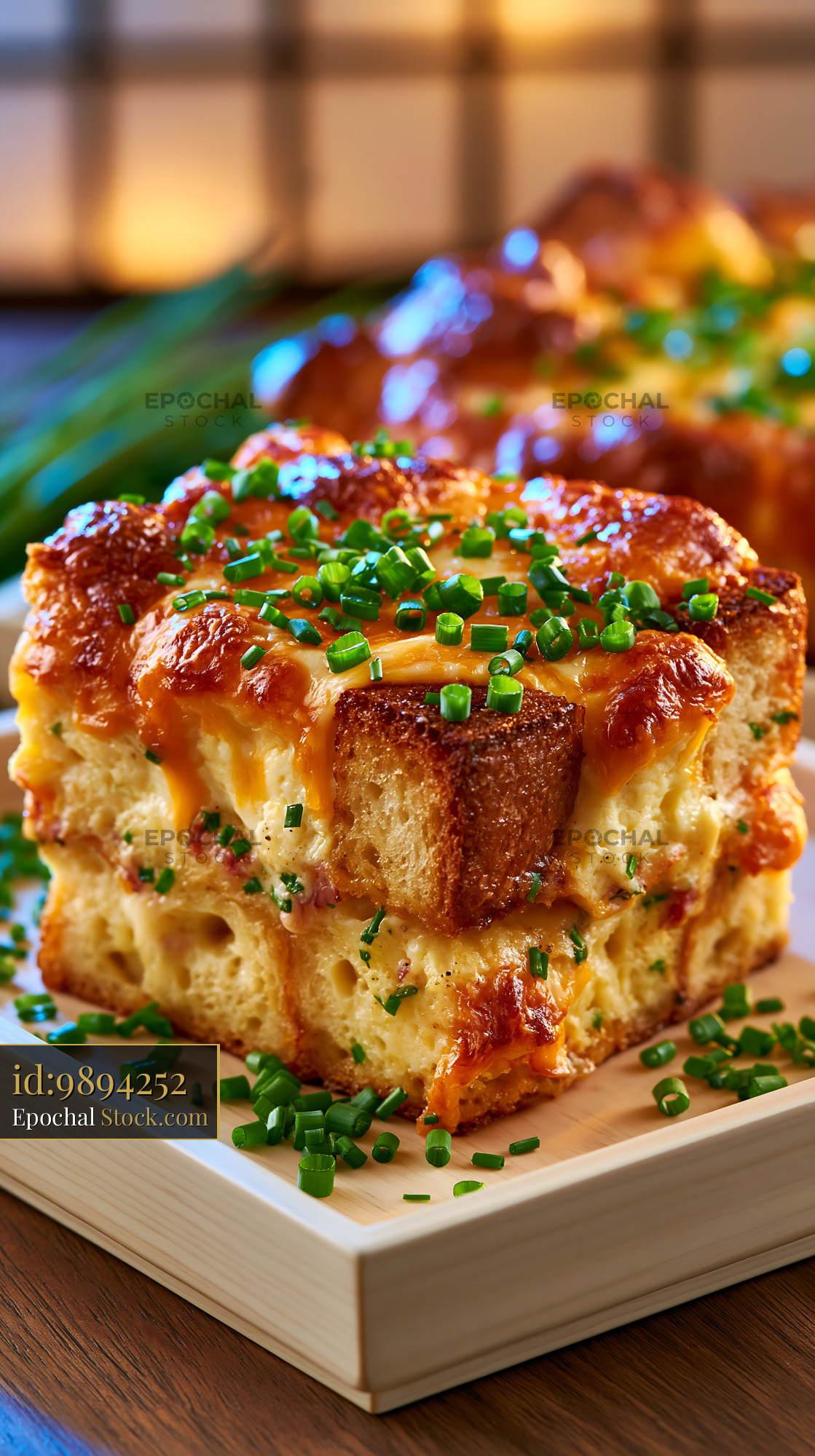 Cheesy breakfast strata egg food topped with fresh chopped chives - stock photo