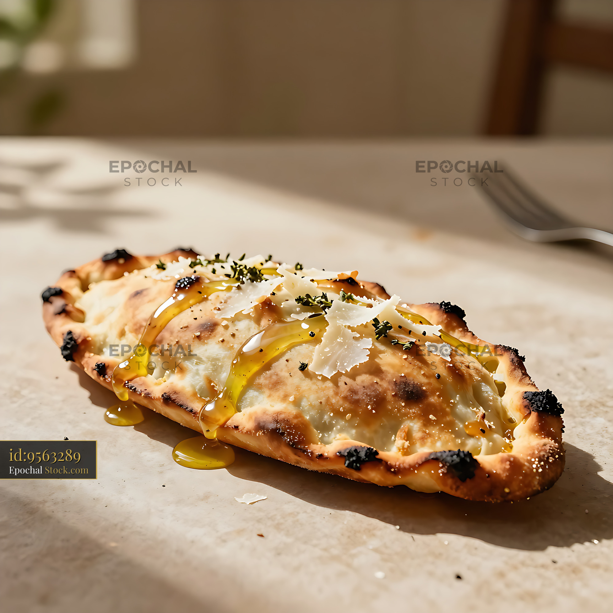 Freshly baked calzone romano with pecorino cheese and honey drizzle - stock photo
