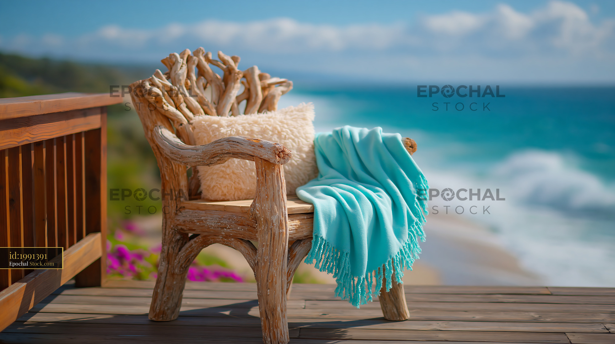 Rustic driftwood armchair with turquoise throw on a coastal deck - stock photo