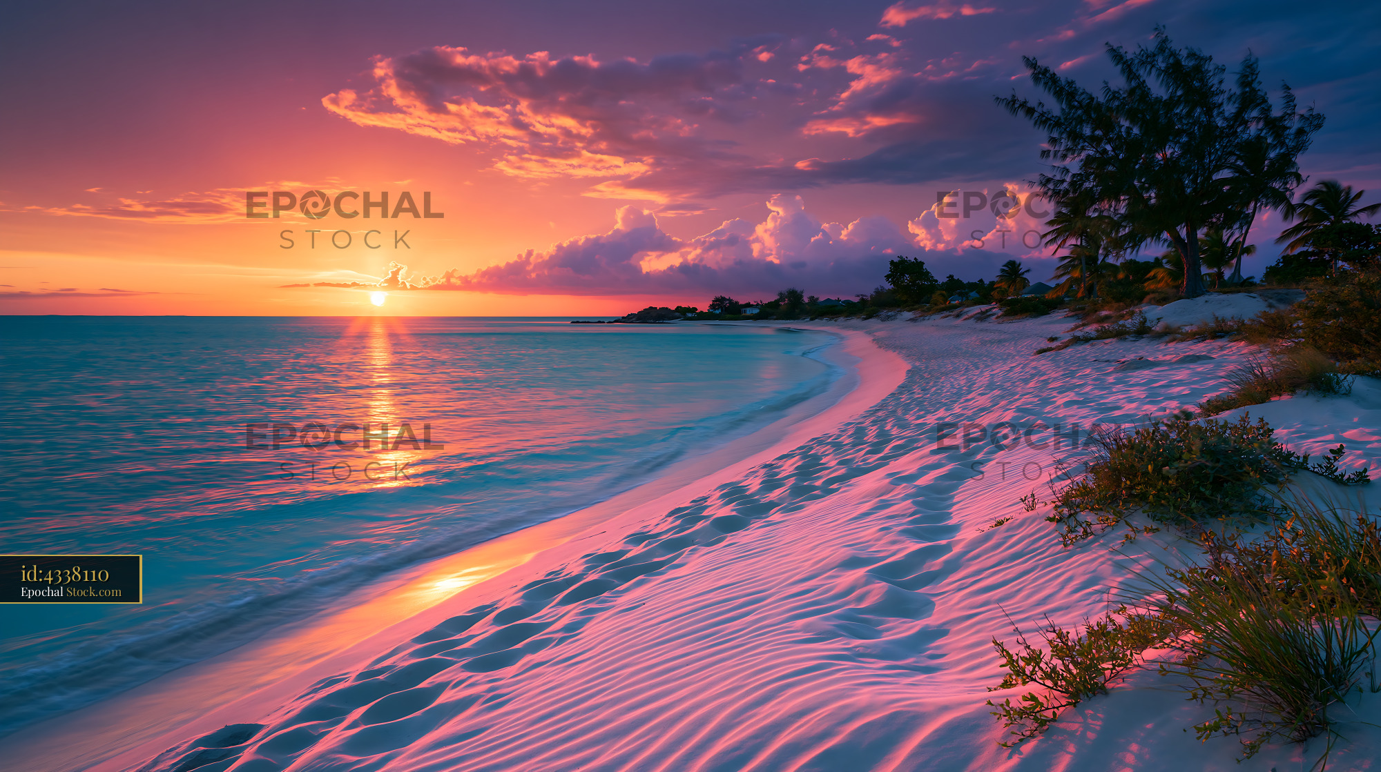 Tropical beach with white sand and palm trees at vibrant sunset - stock photo