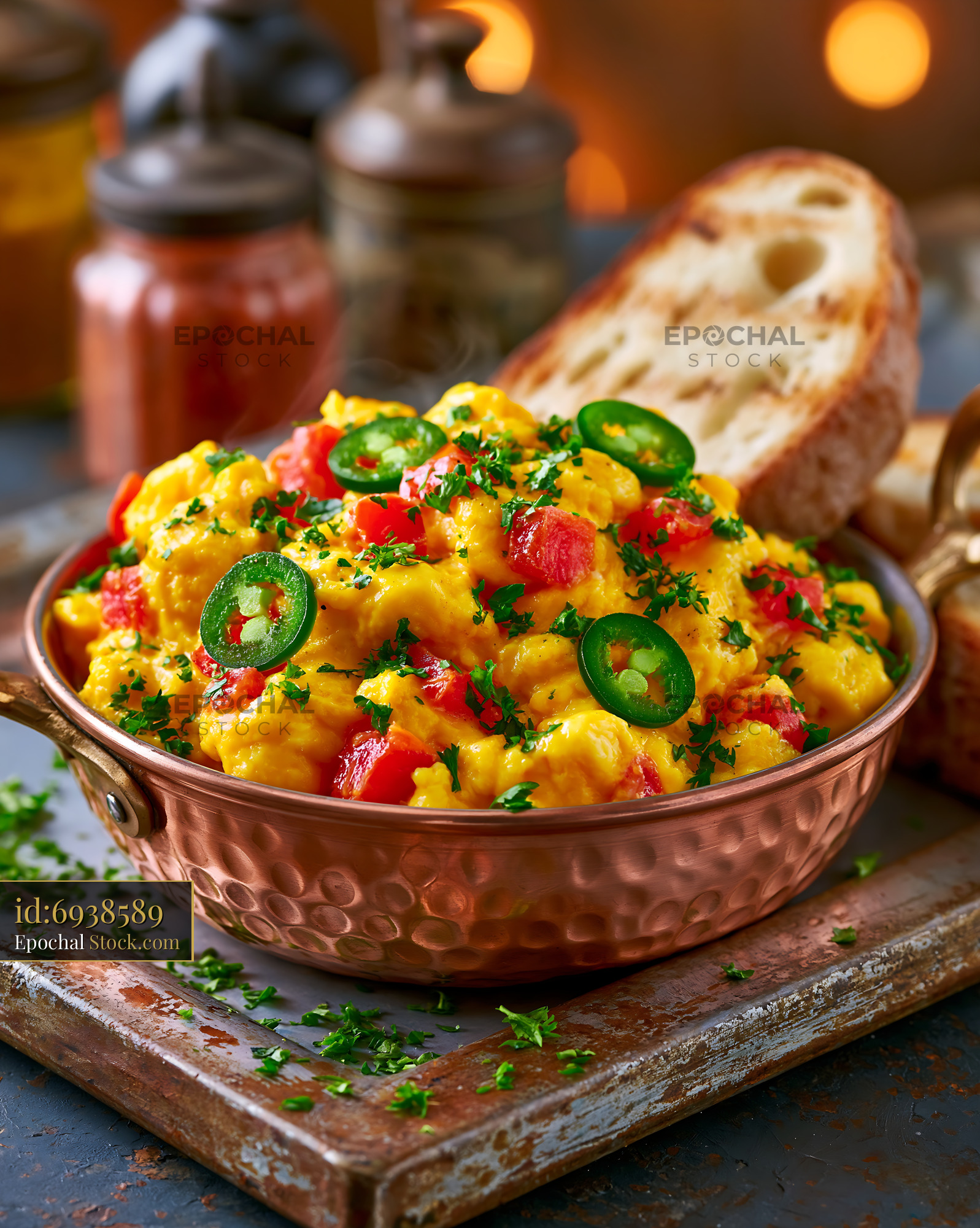 Akuri egg food served in a copper pan with toasted bread - stock photo