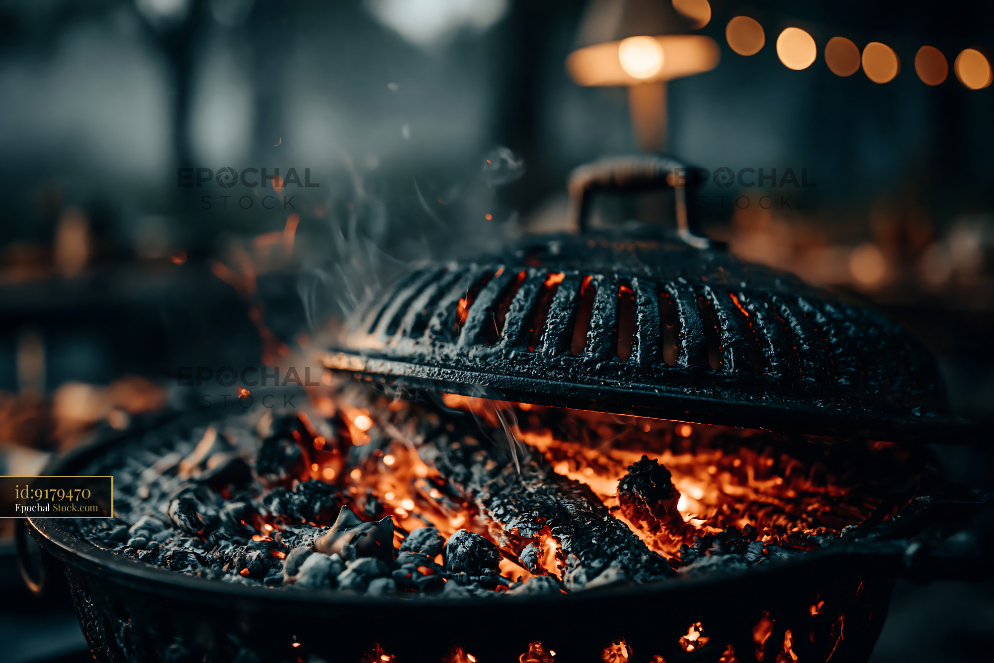 Hot charcoal grill with glowing embers at an evening garden party - stock photo