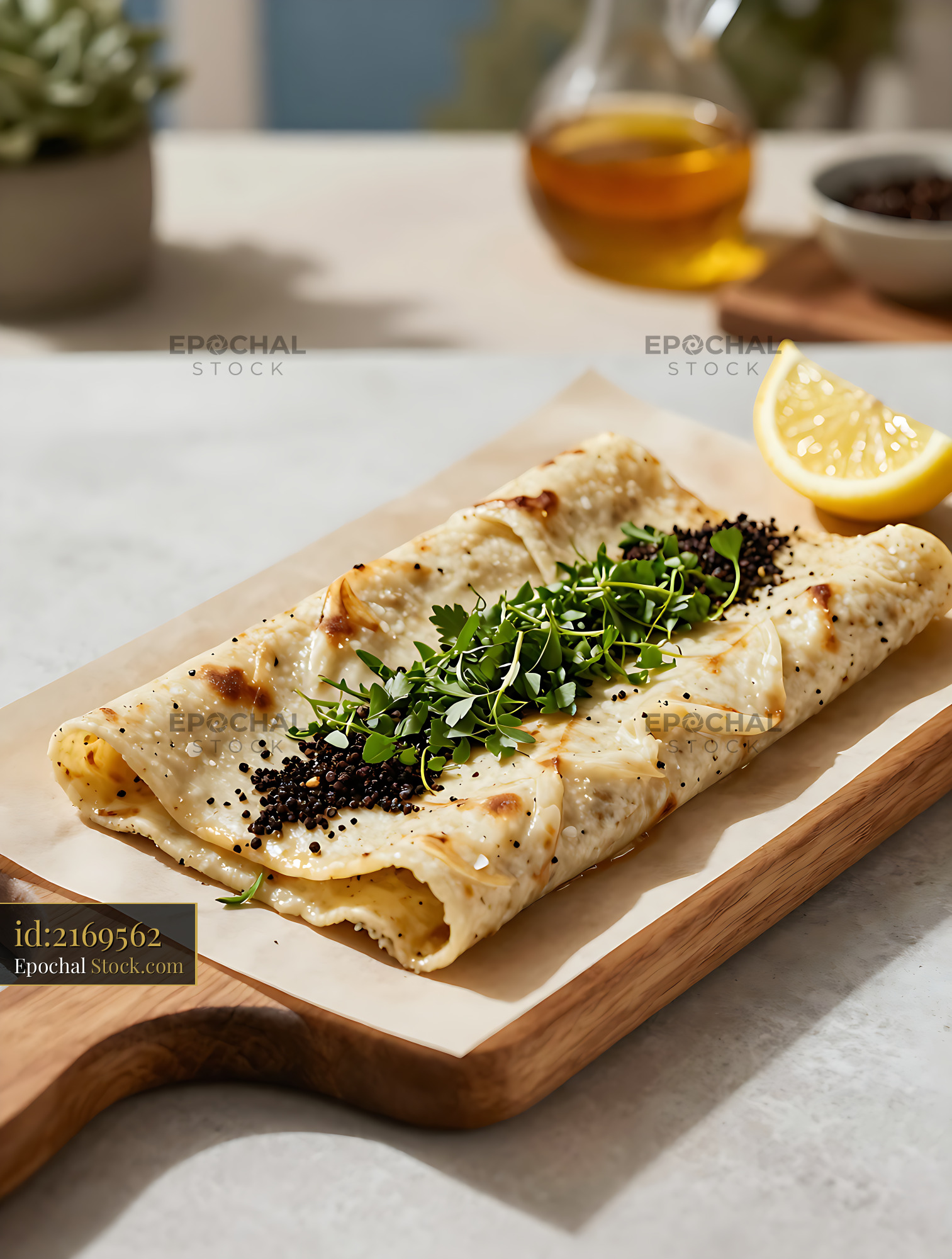 Turkish doner durum roll with fresh herbs and lemon on wooden board - stock photo