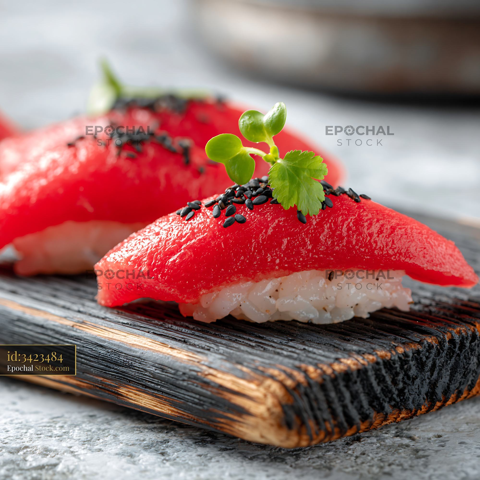 Watermelon tuna sushi served as vegan nigiri on charred wood - stock photo
