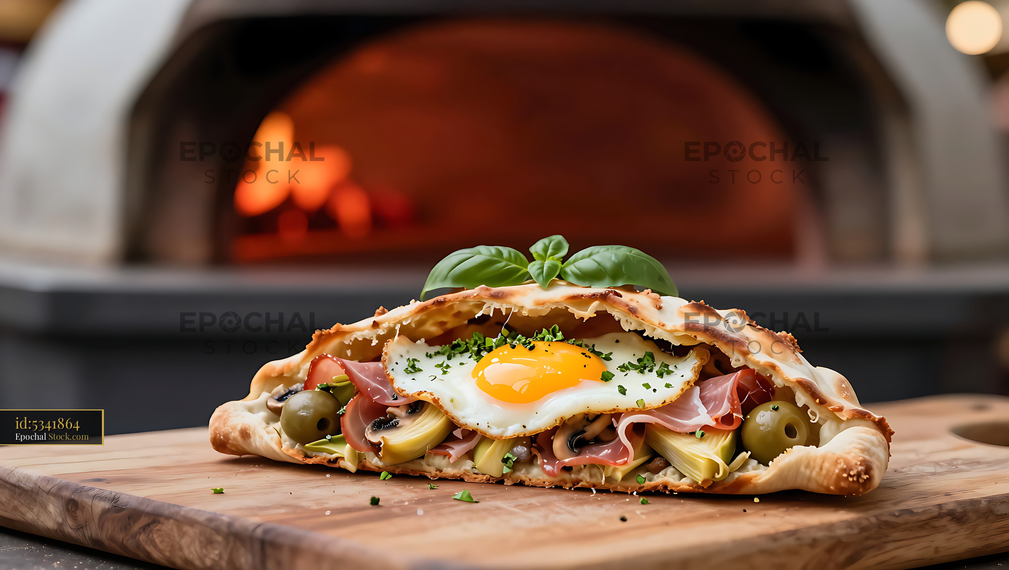 Freshly baked calzone quattro stagioni with a fried egg crown - stock photo