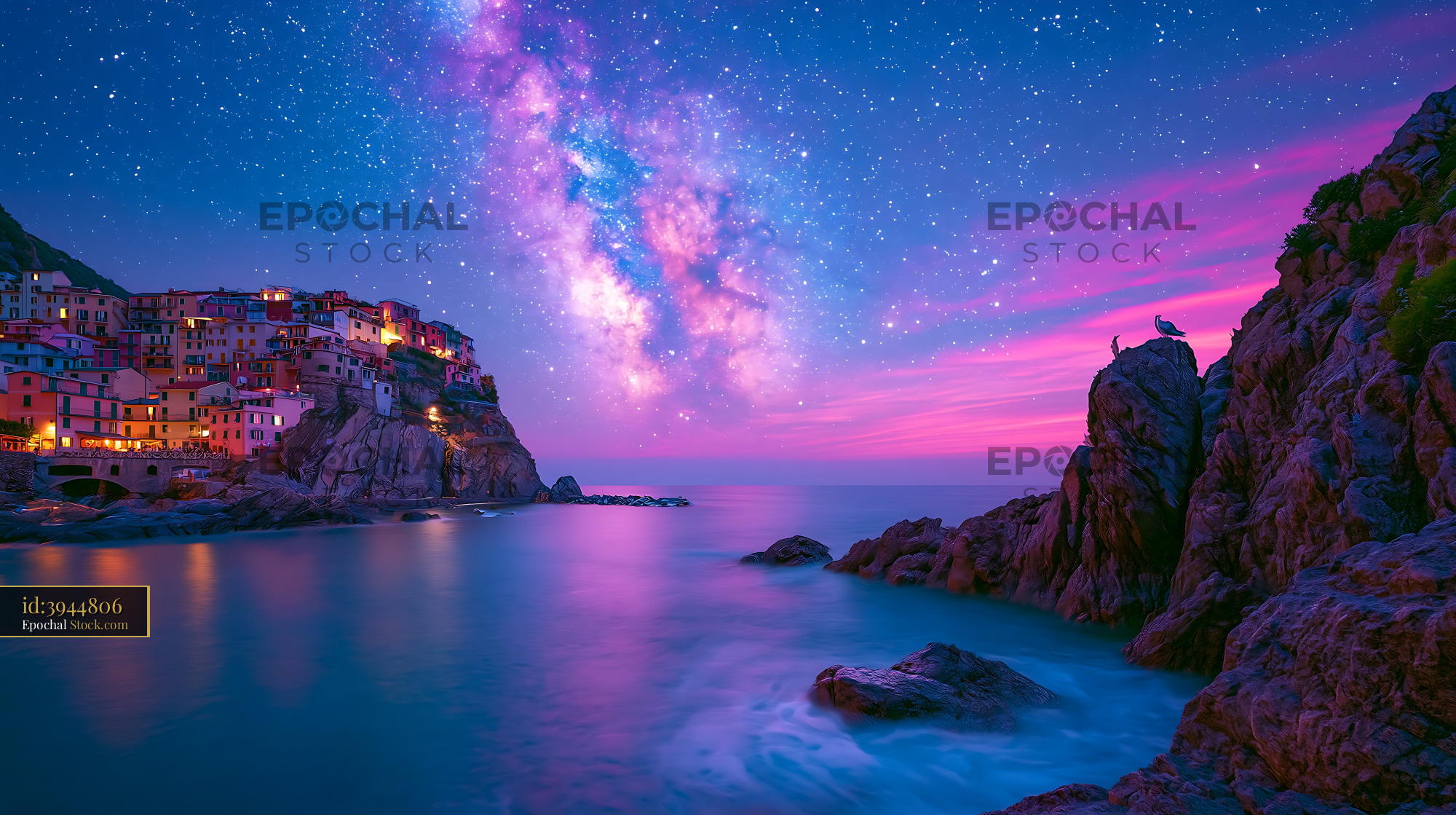 Coastal village on cliffs under vibrant Milky Way and pink twilight sk - stock photo