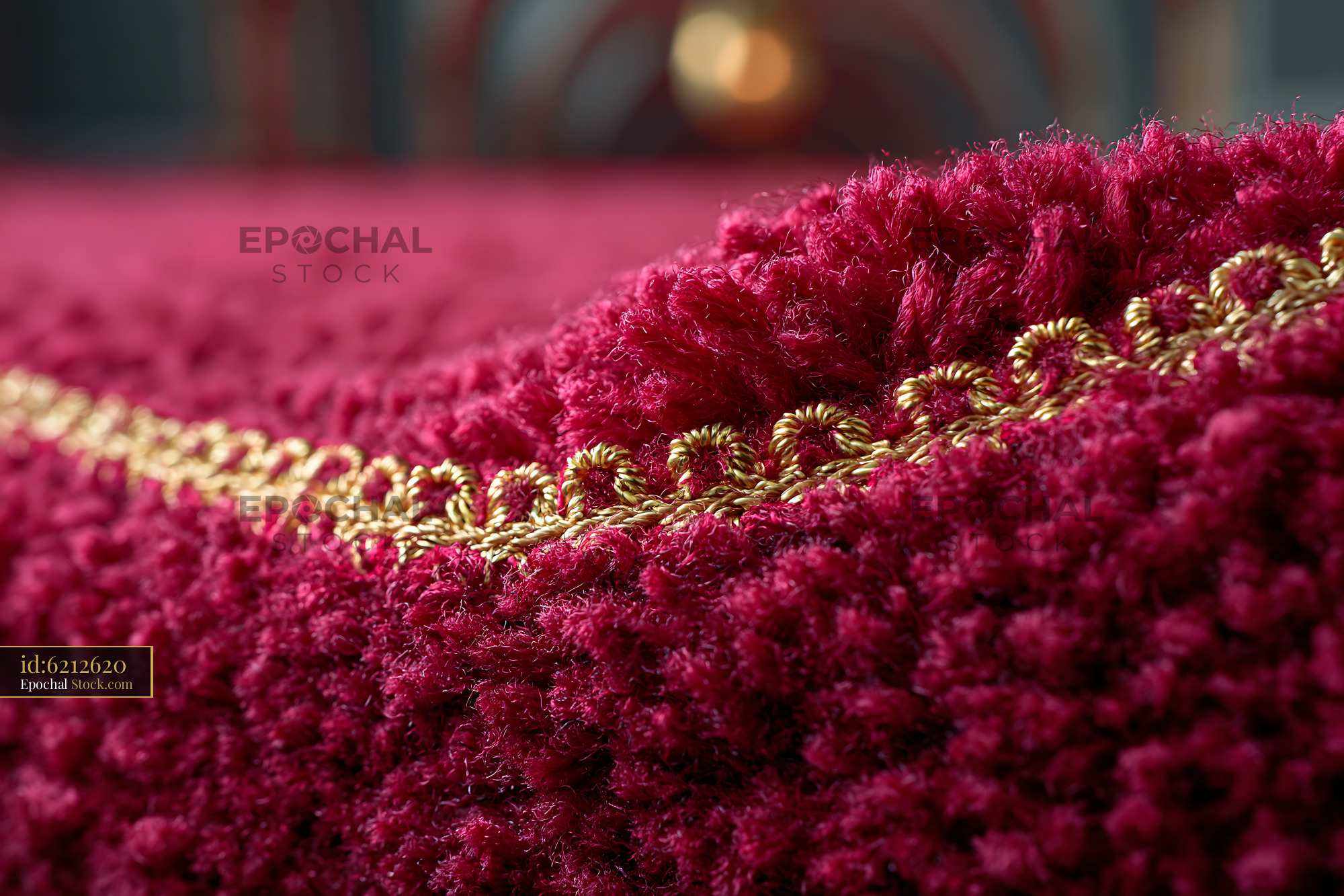 Close up of burgundy theater curtain with gold trim in empty hall - stock photo
