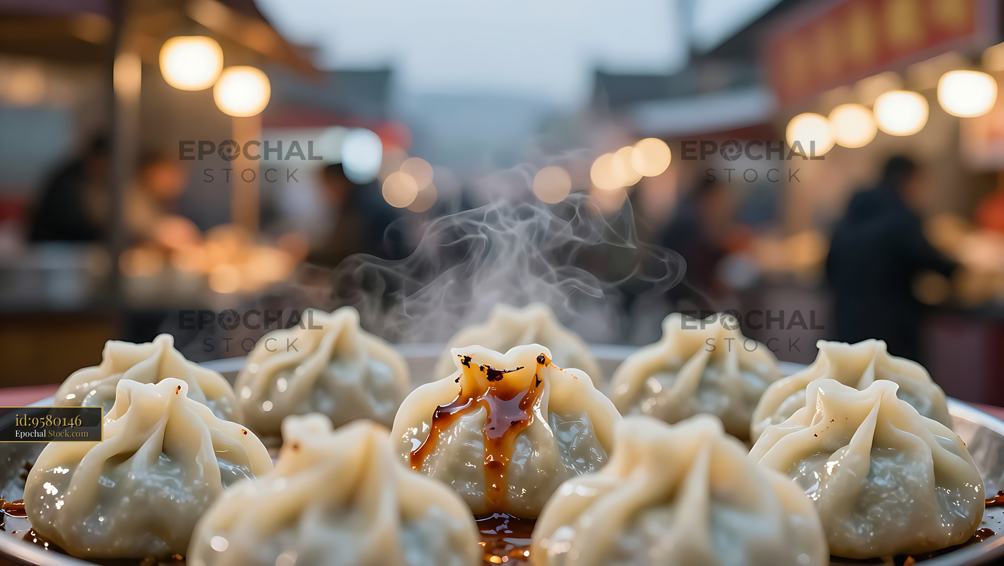 Steaming Tibetan pork momos drizzled with sauce at a night market - stock photo