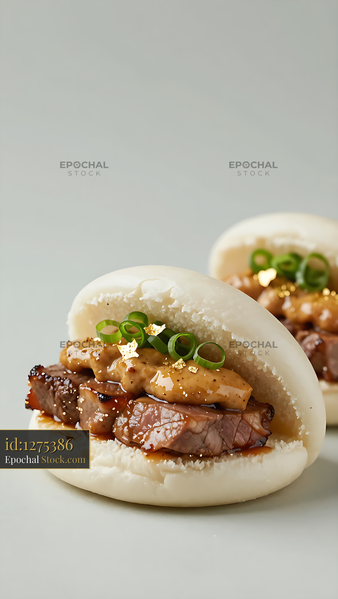 Gourmet wagyu beef and foie gras bao buns with gold leaf garnish - stock photo