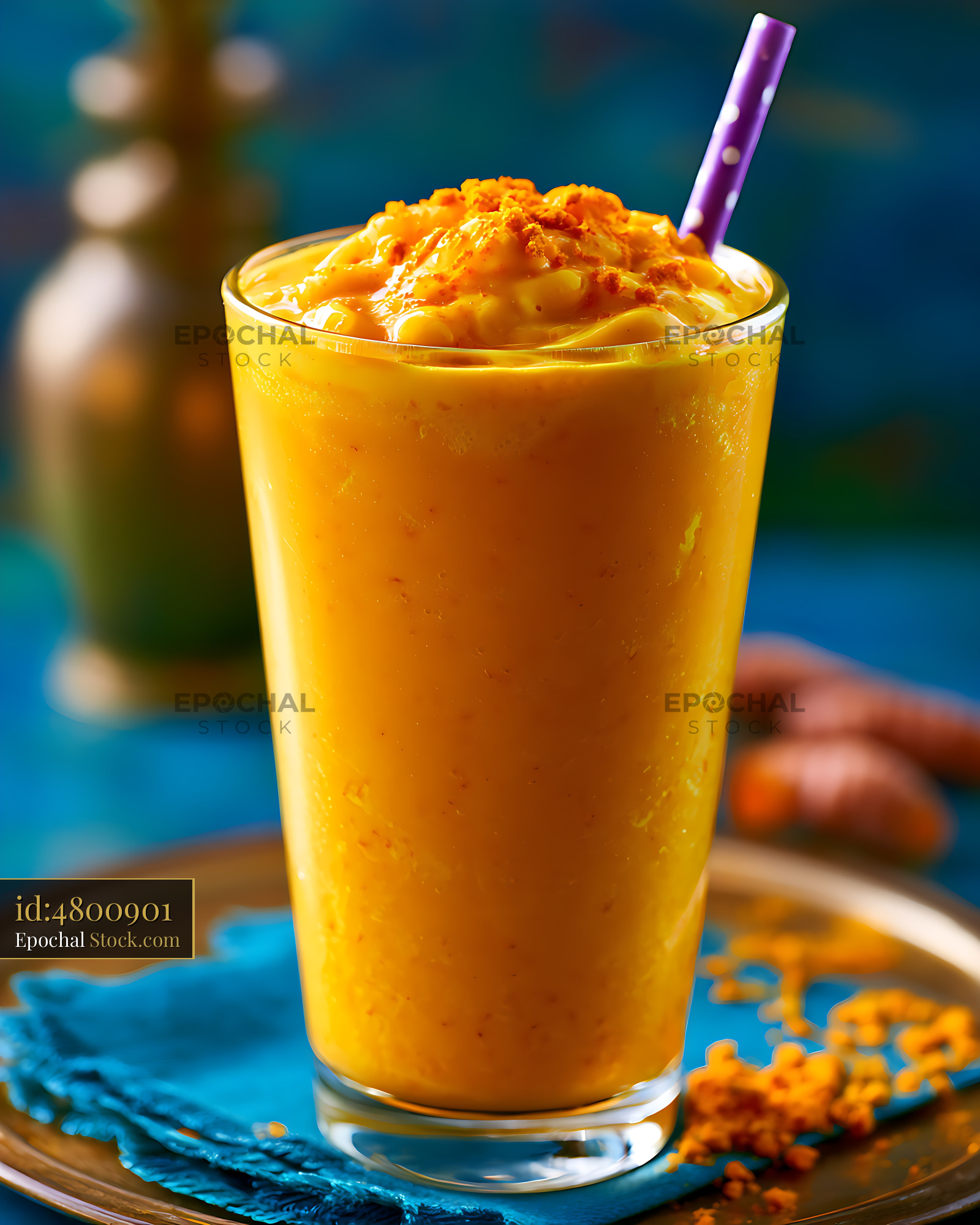 Turmeric latte smoothie with golden milk spices on a blue background - stock photo