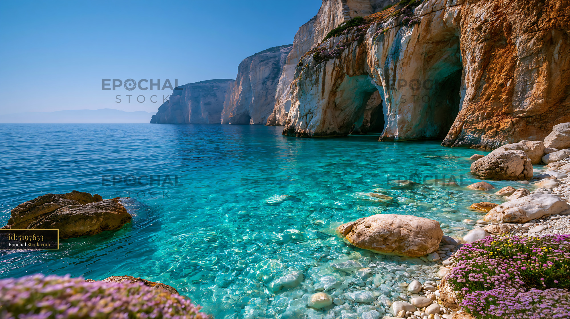 Turquoise mediterranean cove with white limestone cliffs and sea caves - stock photo