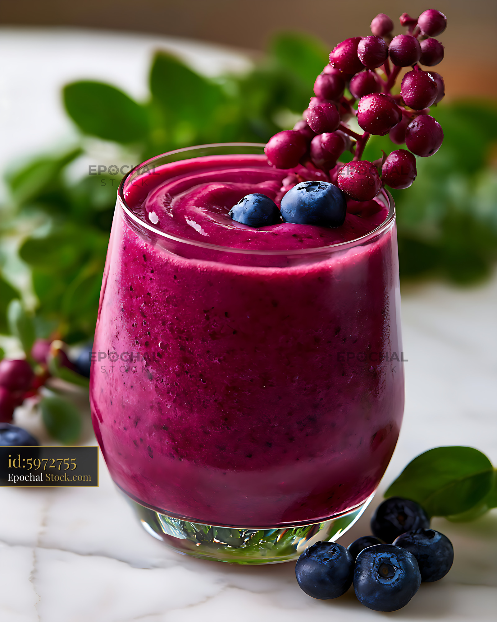 Vibrant purple maqui berry smoothie topped with fresh blueberries - stock photo