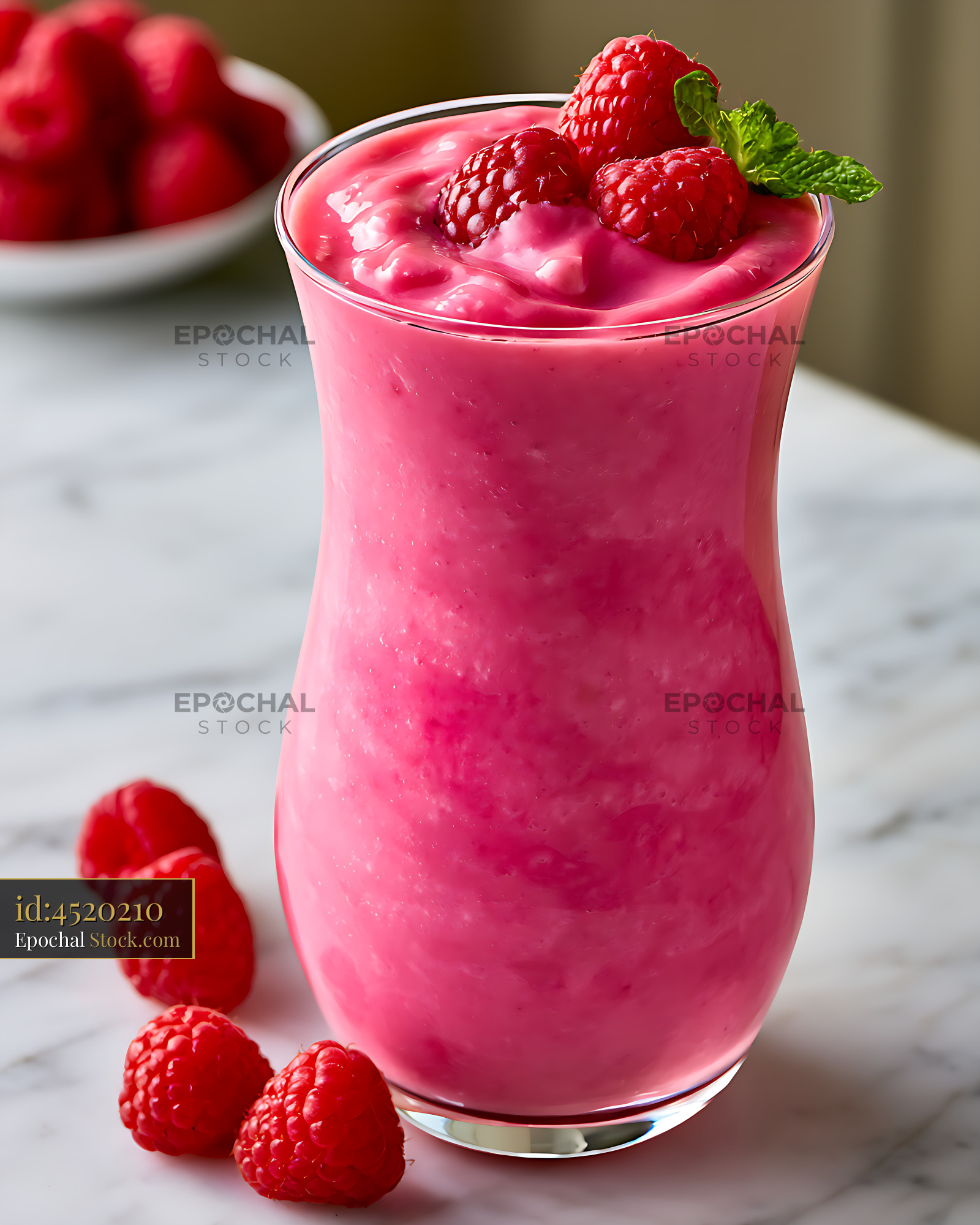 Creamy french raspberry smoothie topped with fresh berries and mint - stock photo
