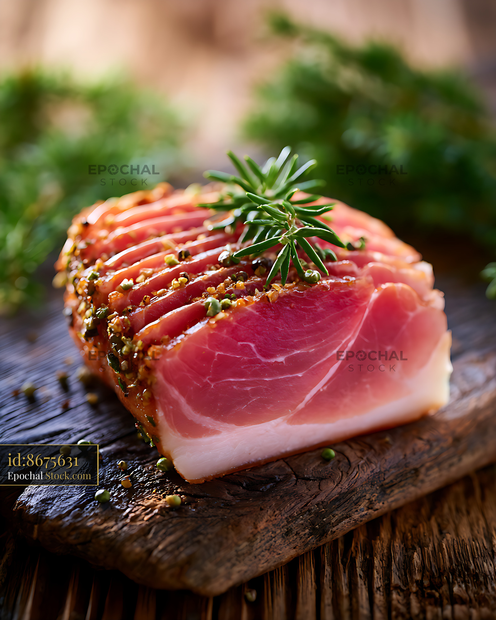 Sliced speck alto adige cured ham with herbs on a wooden board - stock photo