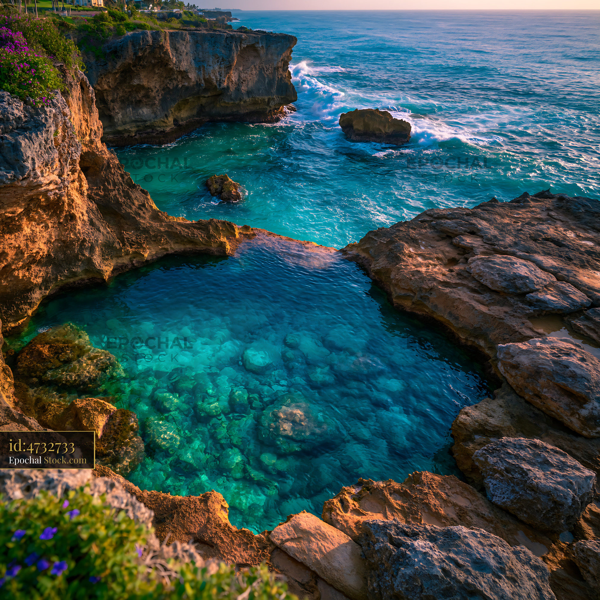 Natural coral pool with turquoise water at a rocky coastal cliff