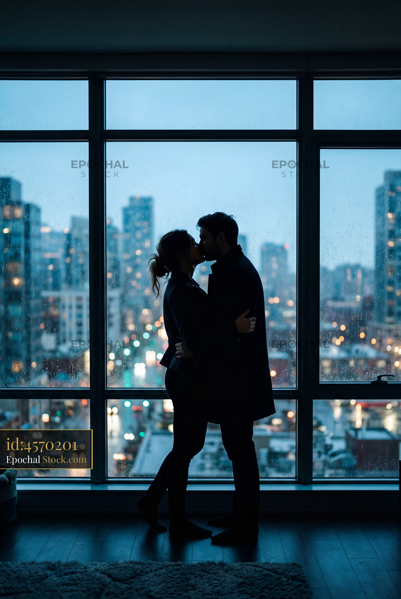 Couple sharing a moment in a city apartment at night Premium Stock Photo - stock photo