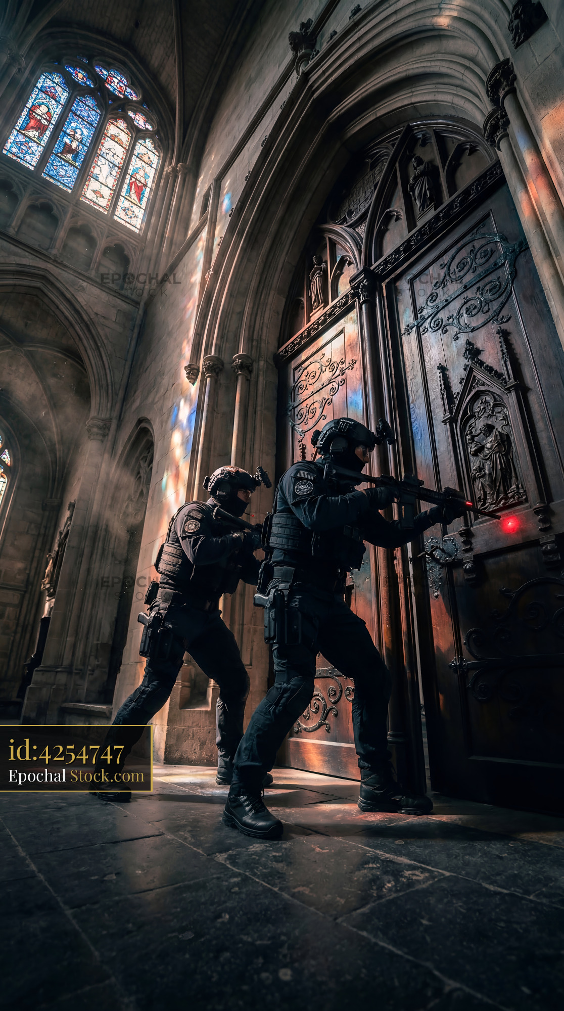 Two officers breach a door inside a historic building Premium Stock Image - stock photo