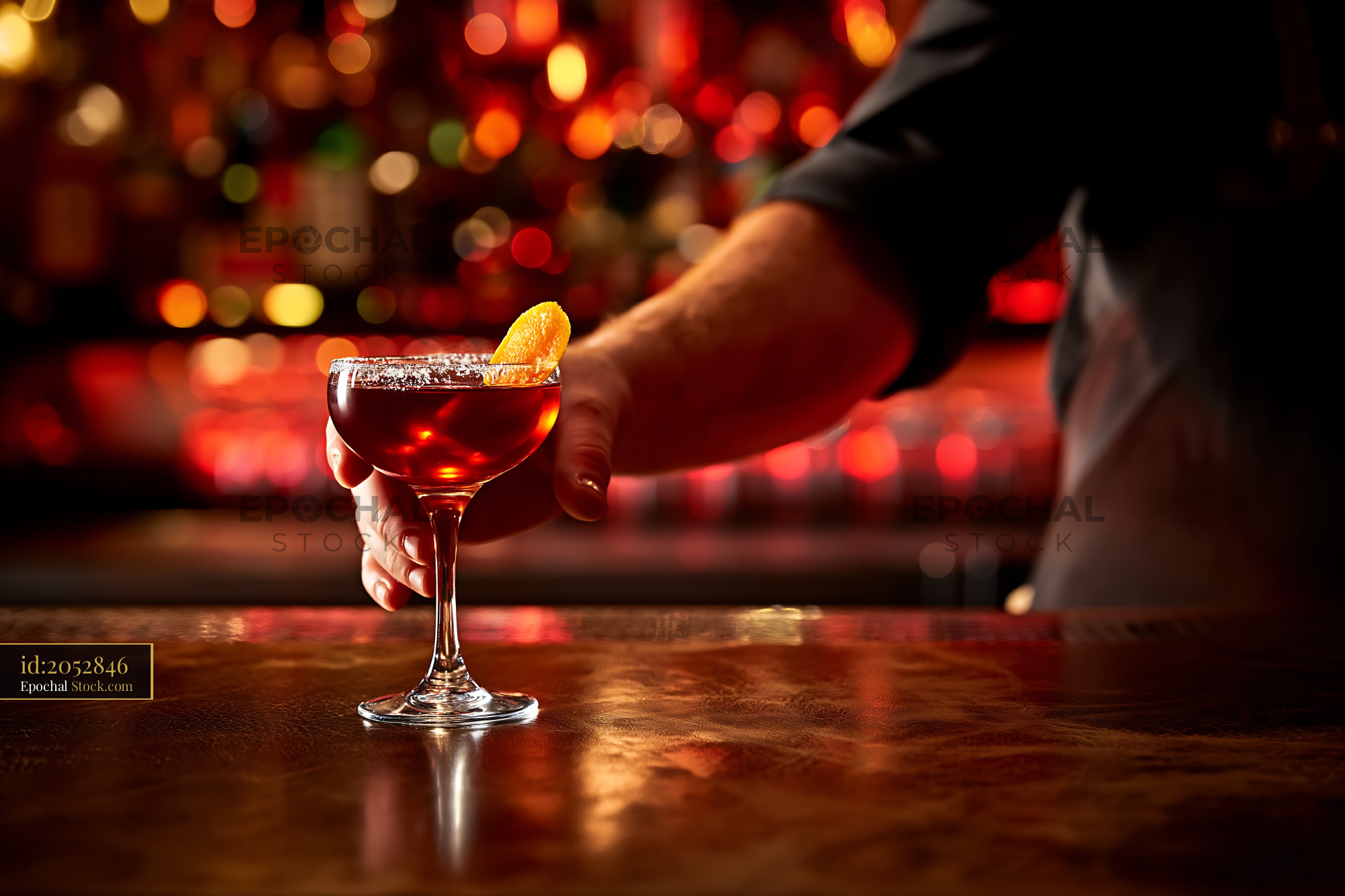 Red Cocktail Drink with Orange Twist at Bar - stock photo